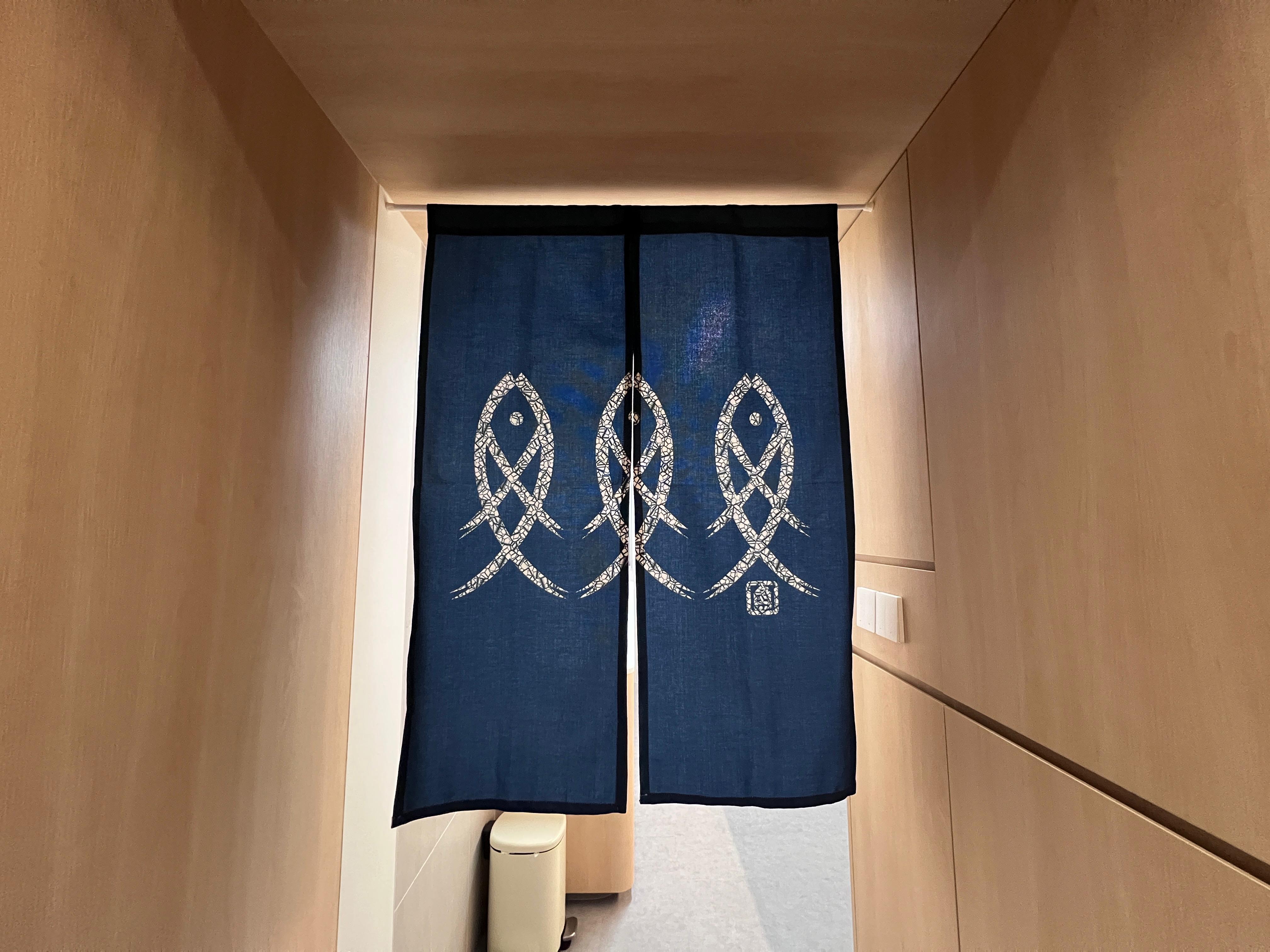 Into our minimalist kitchen - blue curtain with intricate white patterns, wooden interior hallway, minimalist design, soft
