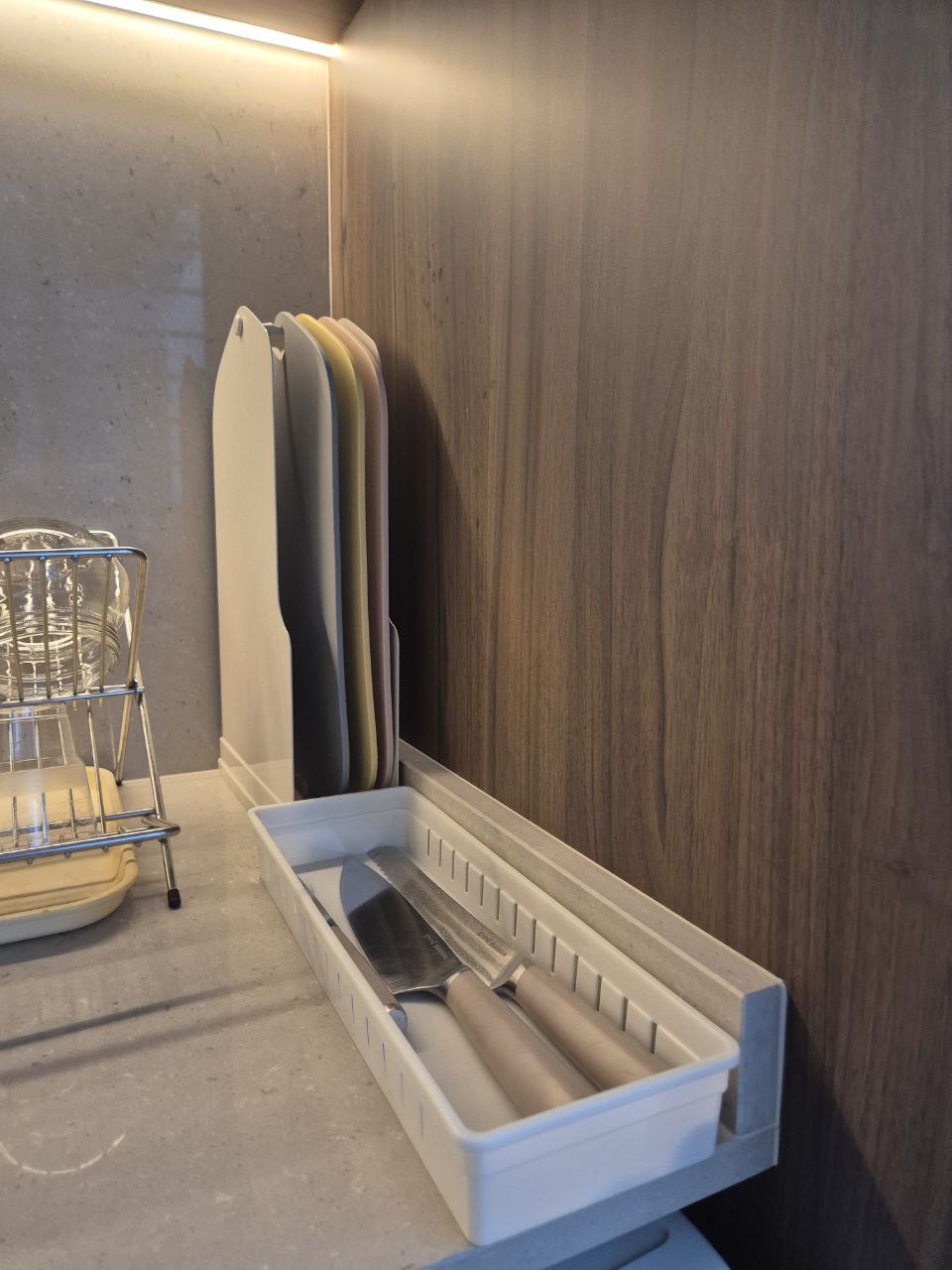 Our Kitchen: endless countertop space - Clear glass dish, wooden wall, stainless steel rack, kitchen utensils, white plastic