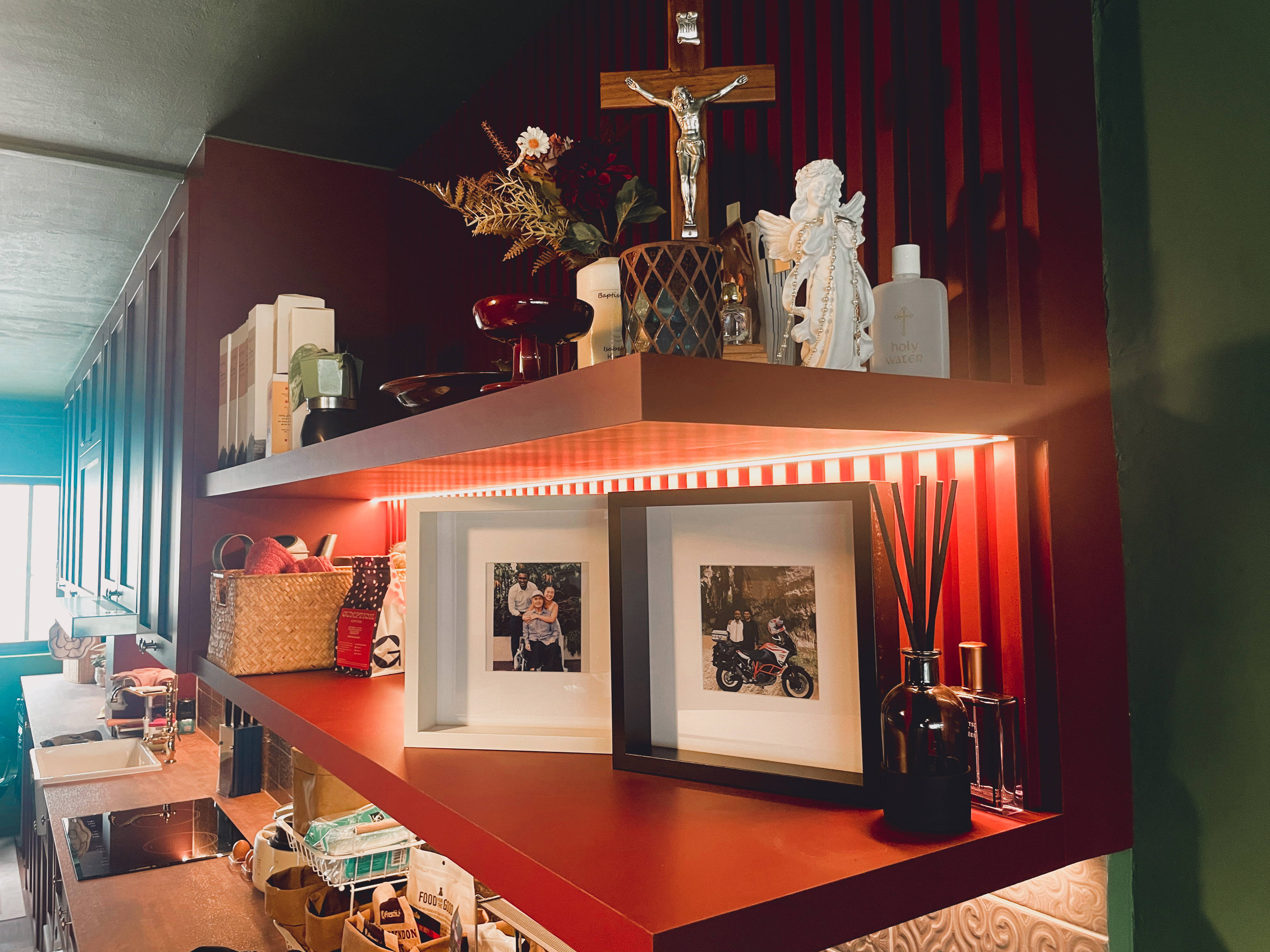 Bold and Unique: Our Open Kitchen with an Unconventional Color Palette - Shelf with religious items, cross, angels, framed
