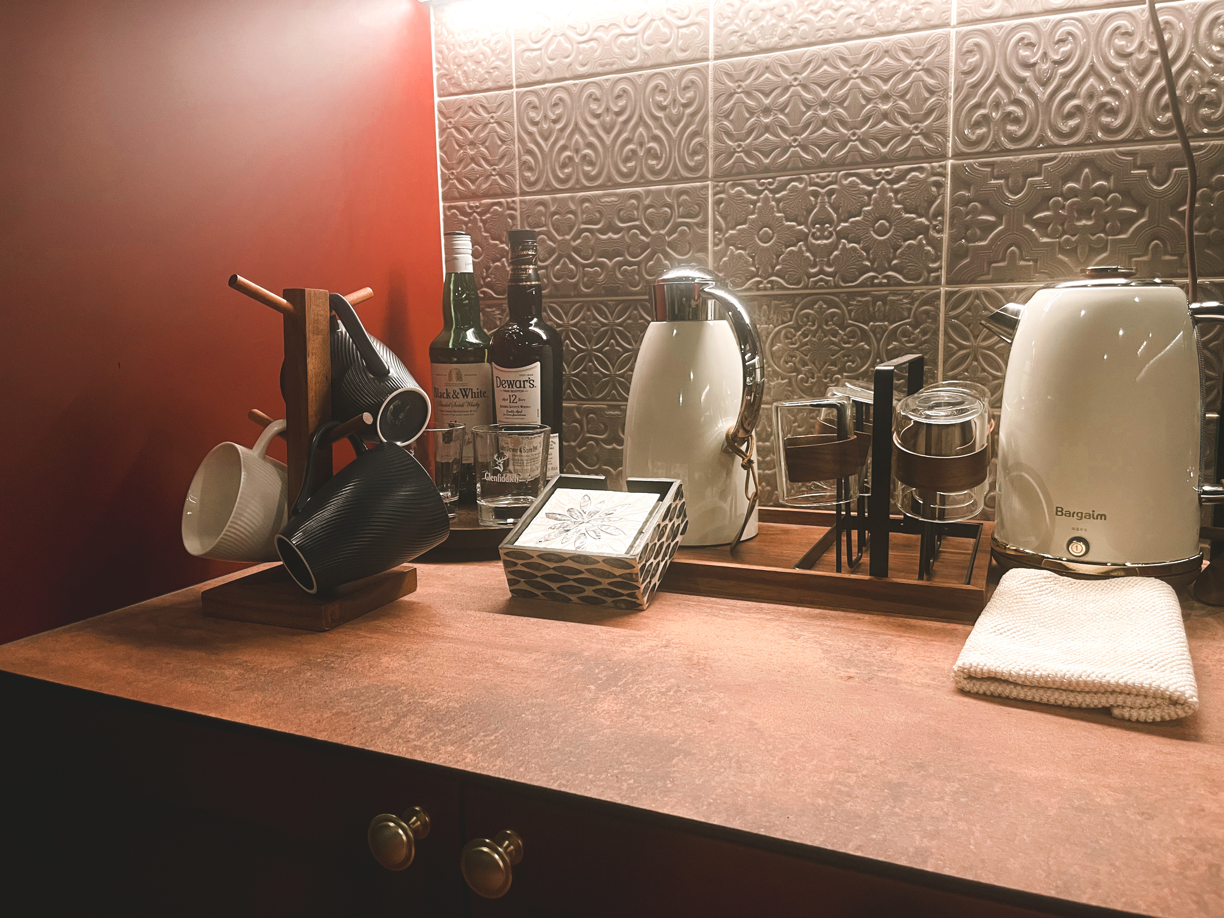 Bold and Unique: Our Open Kitchen with an Unconventional Color Palette - Bargain electric kettle, black and white mugs, wine