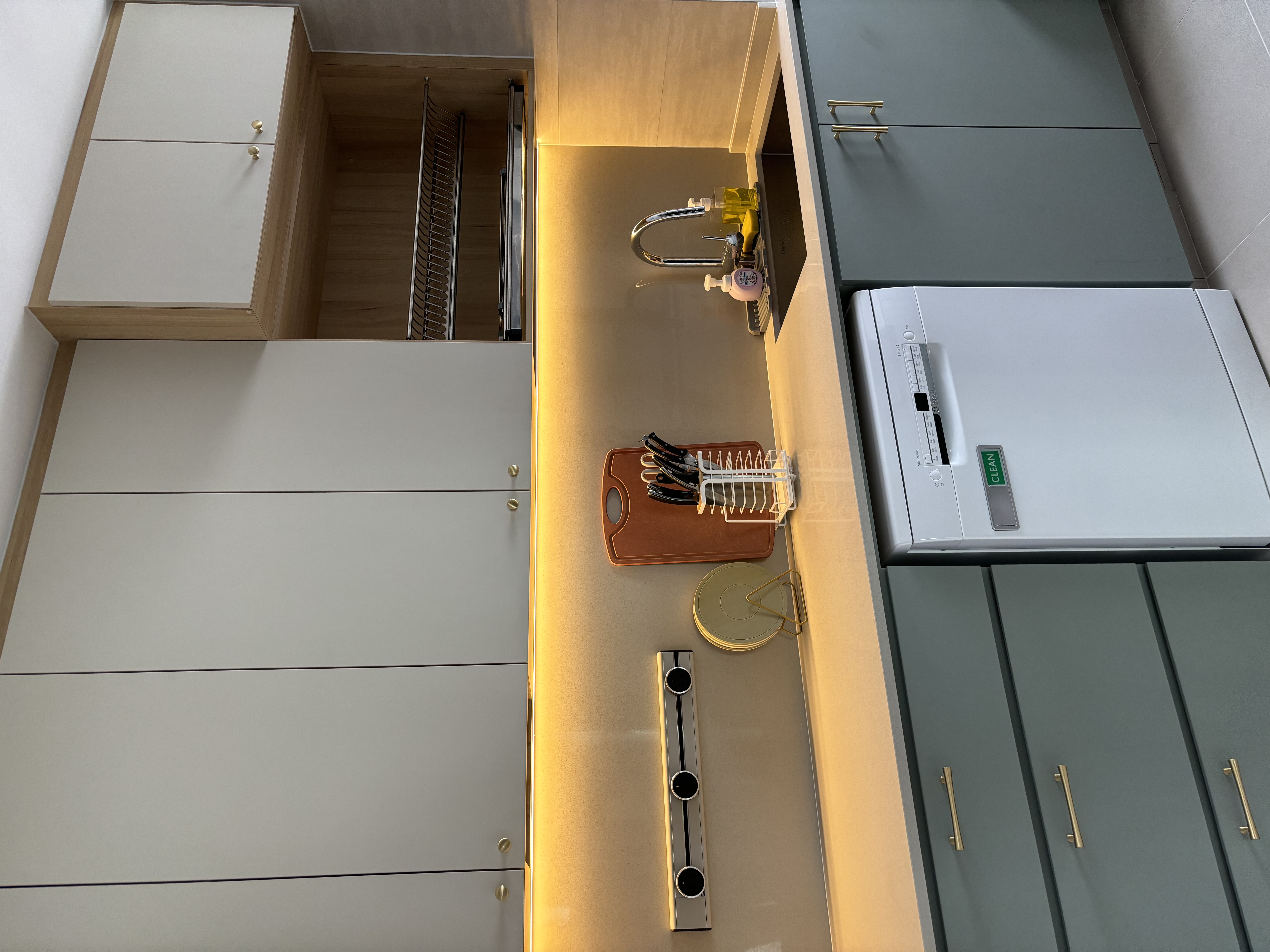 How we maximise countertop space in a fully equipped Green Kitchen - Modern kitchen with sleek cabinets, stainless steel