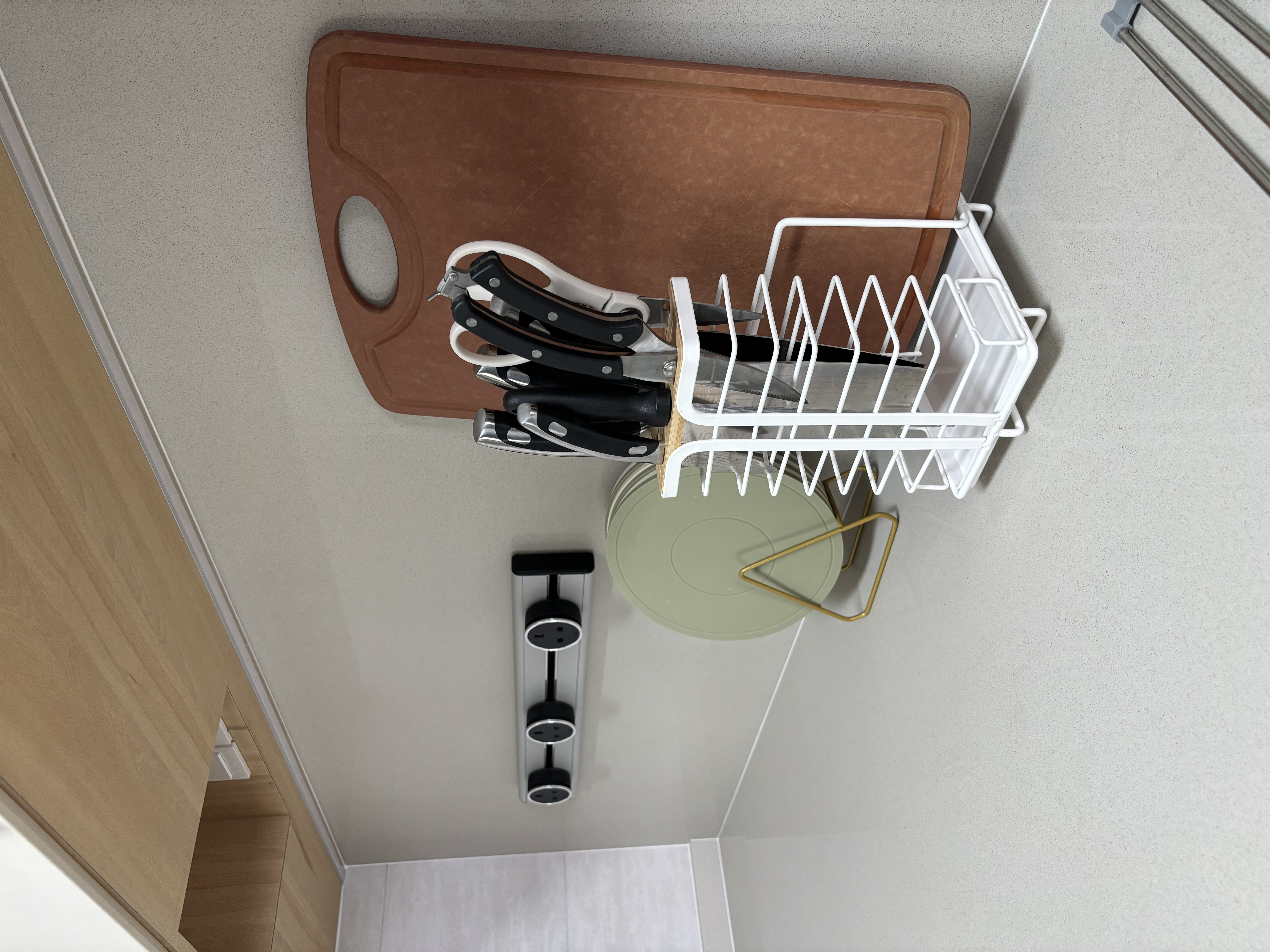 How we maximise countertop space in a fully equipped Green Kitchen - Brown cutting board, knife set, white dish rack, kitchen