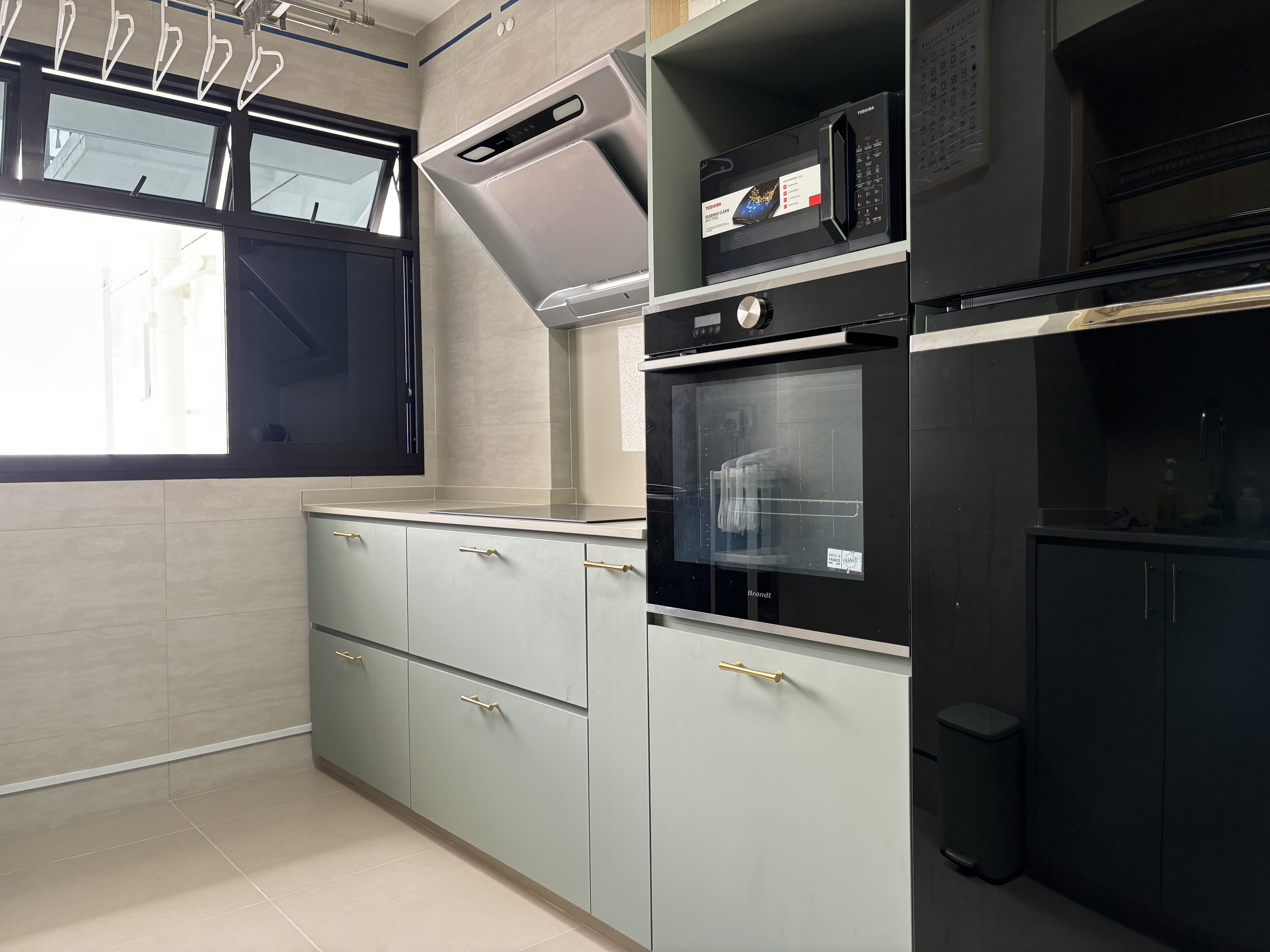 How we maximise countertop space in a fully equipped Green Kitchen - Modern kitchen with sleek appliances, stainless steel