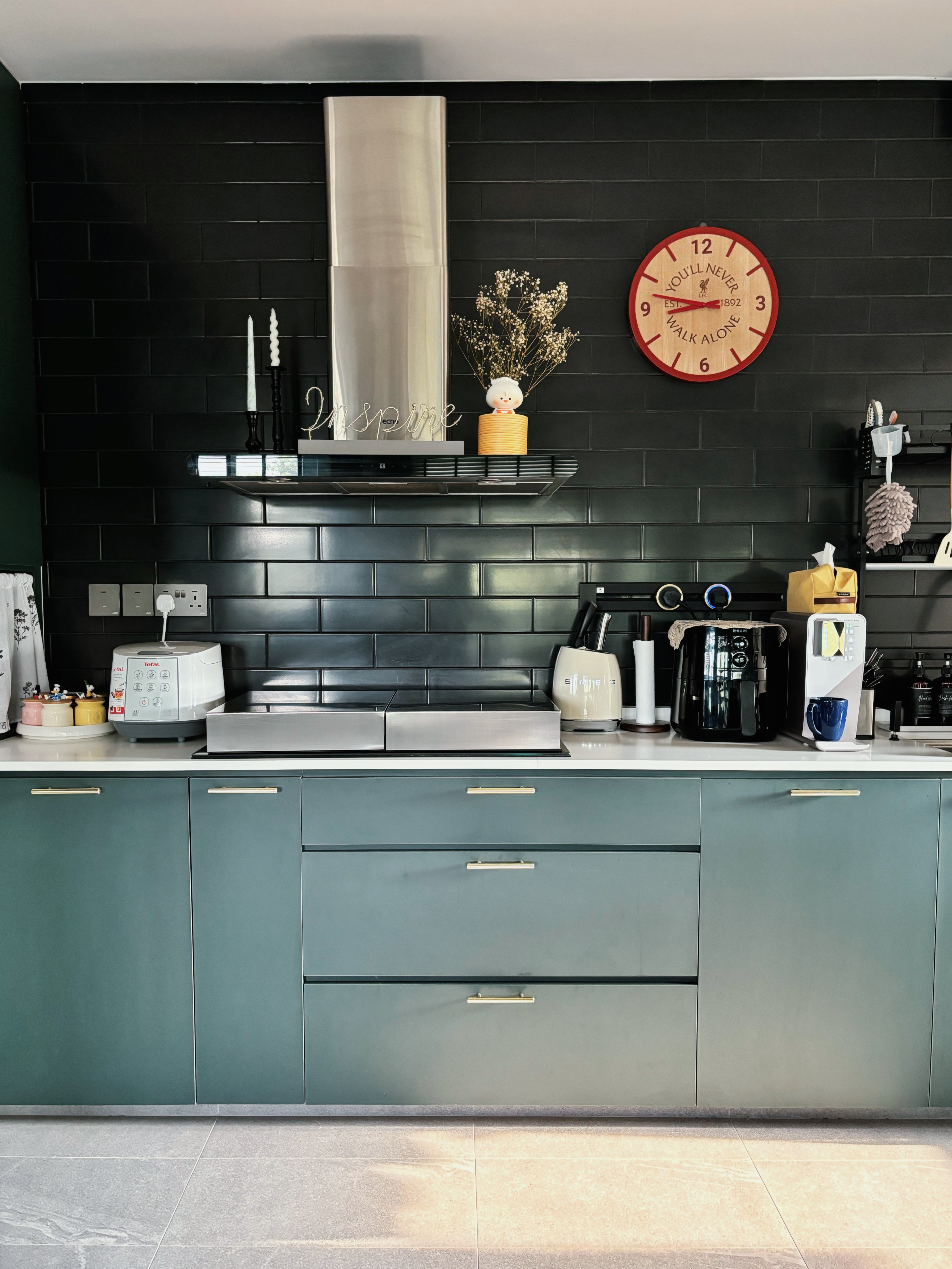 Our Kitchen Recipe - Dark gray kitchen cabinetry, modern appliances, white countertop, stainless steel appliances, white