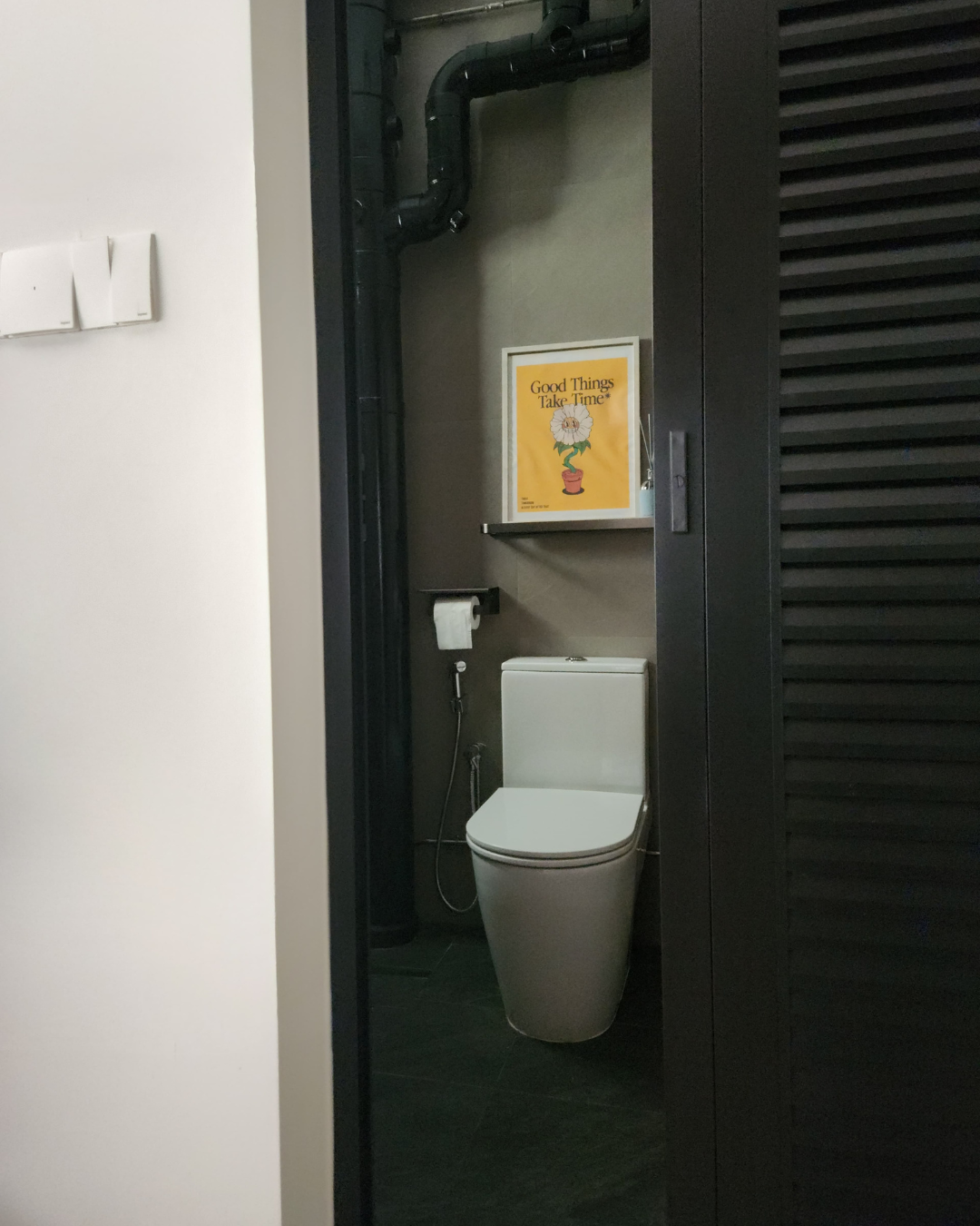 One aspect that we would redo for our toilets - Modern bathroom, minimalist design, white toilet, black pipes, yellow poster