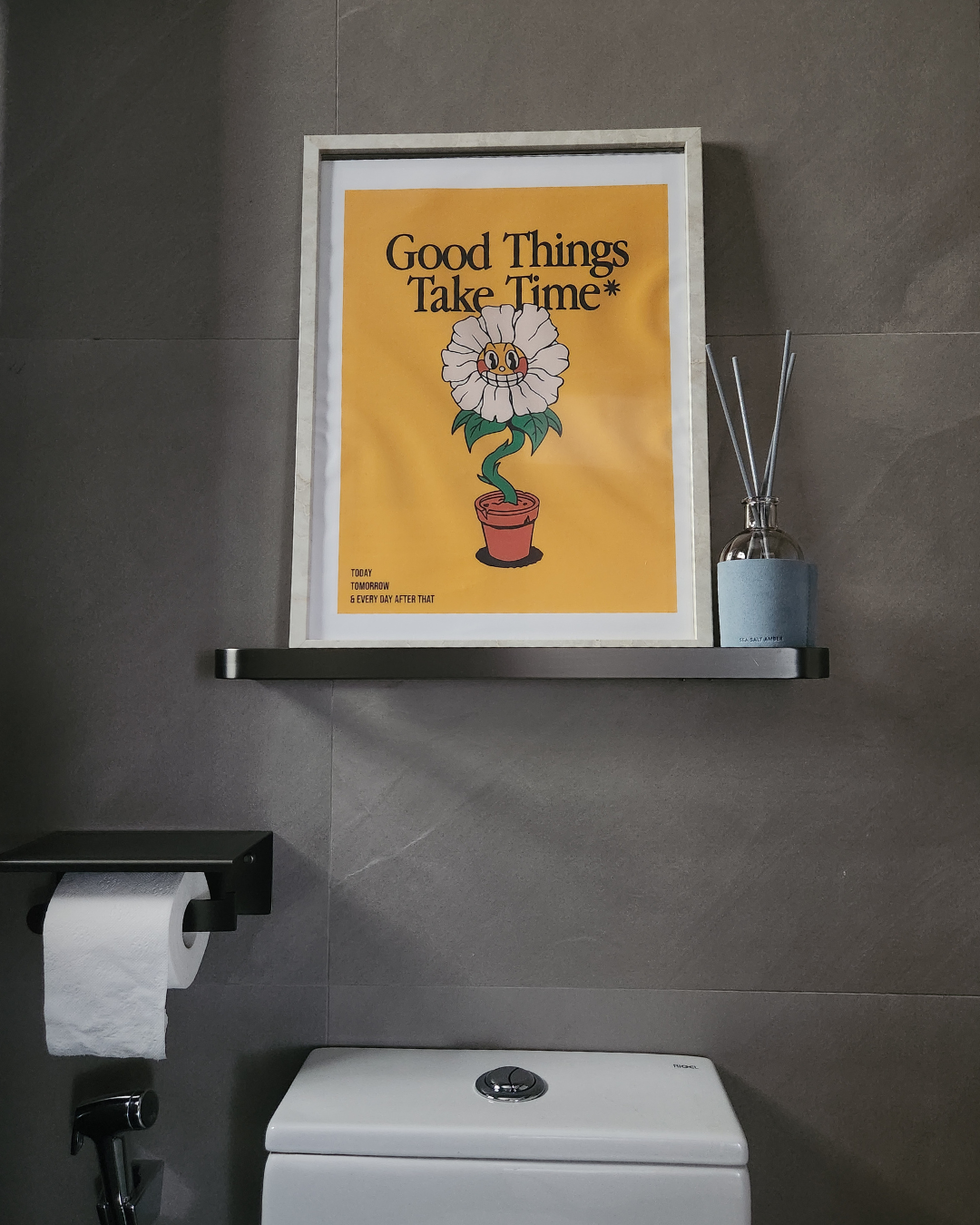 One aspect that we would redo for our toilets - Yellow poster with "Good Things Take Time*" illustration, black shelf with