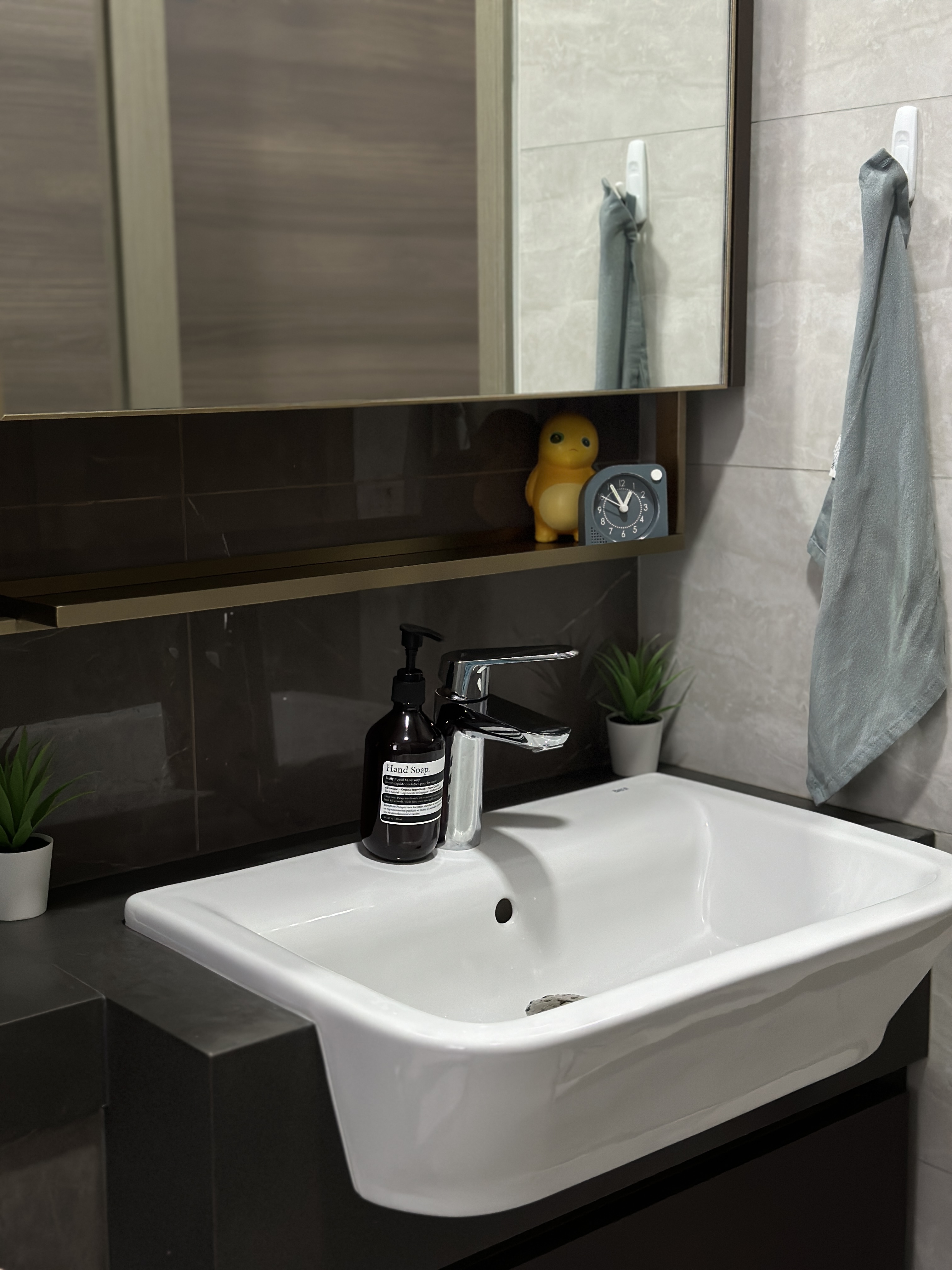 Minimalist Bathroom with a touch of mindfulness 🌿 - White modern bathroom sink, sleek faucet, black soap dispenser, gray