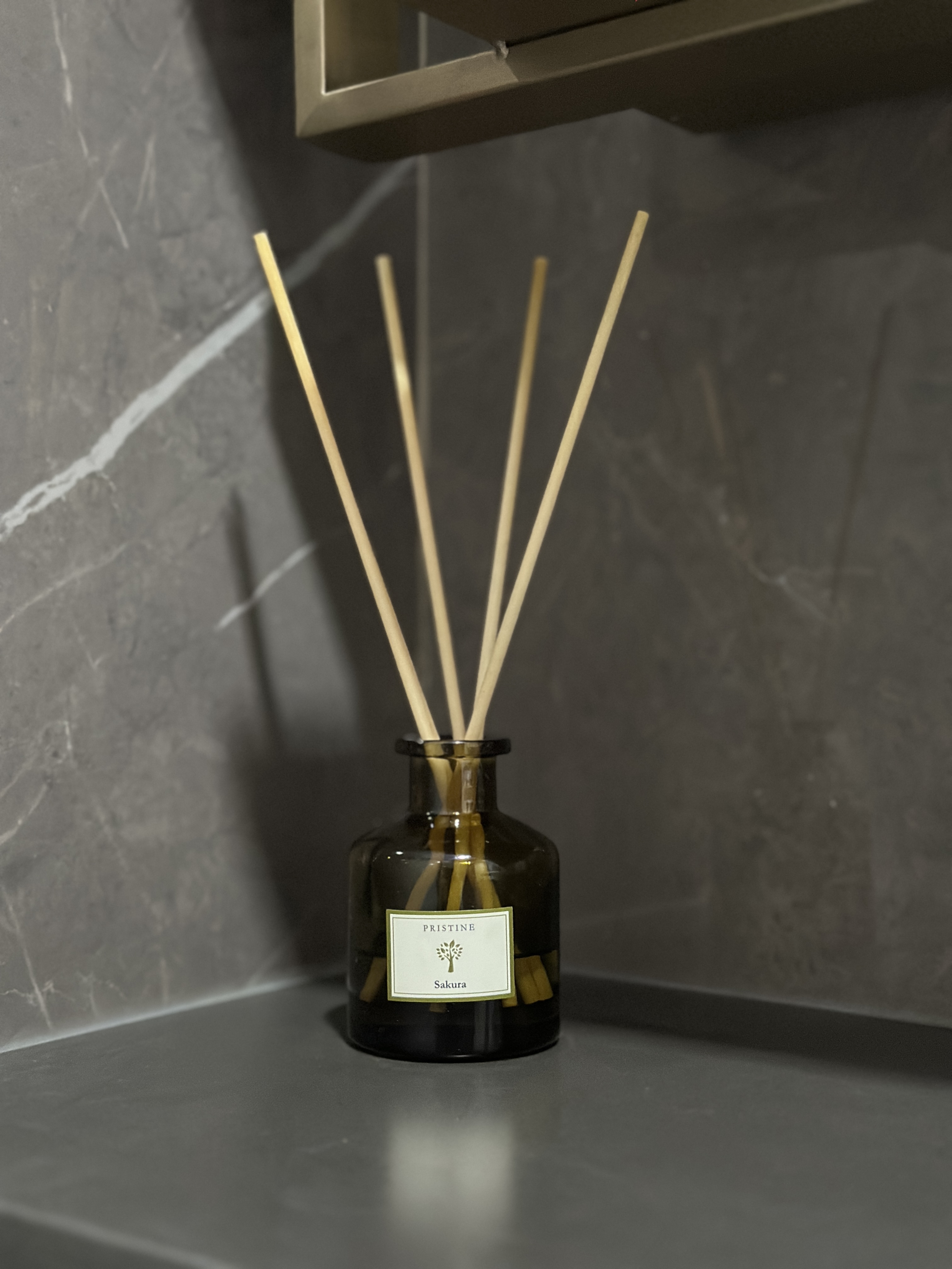 Minimalist Bathroom with a touch of mindfulness 🌿 - glass vase, wooden sticks, elegant arrangement, dark marble background