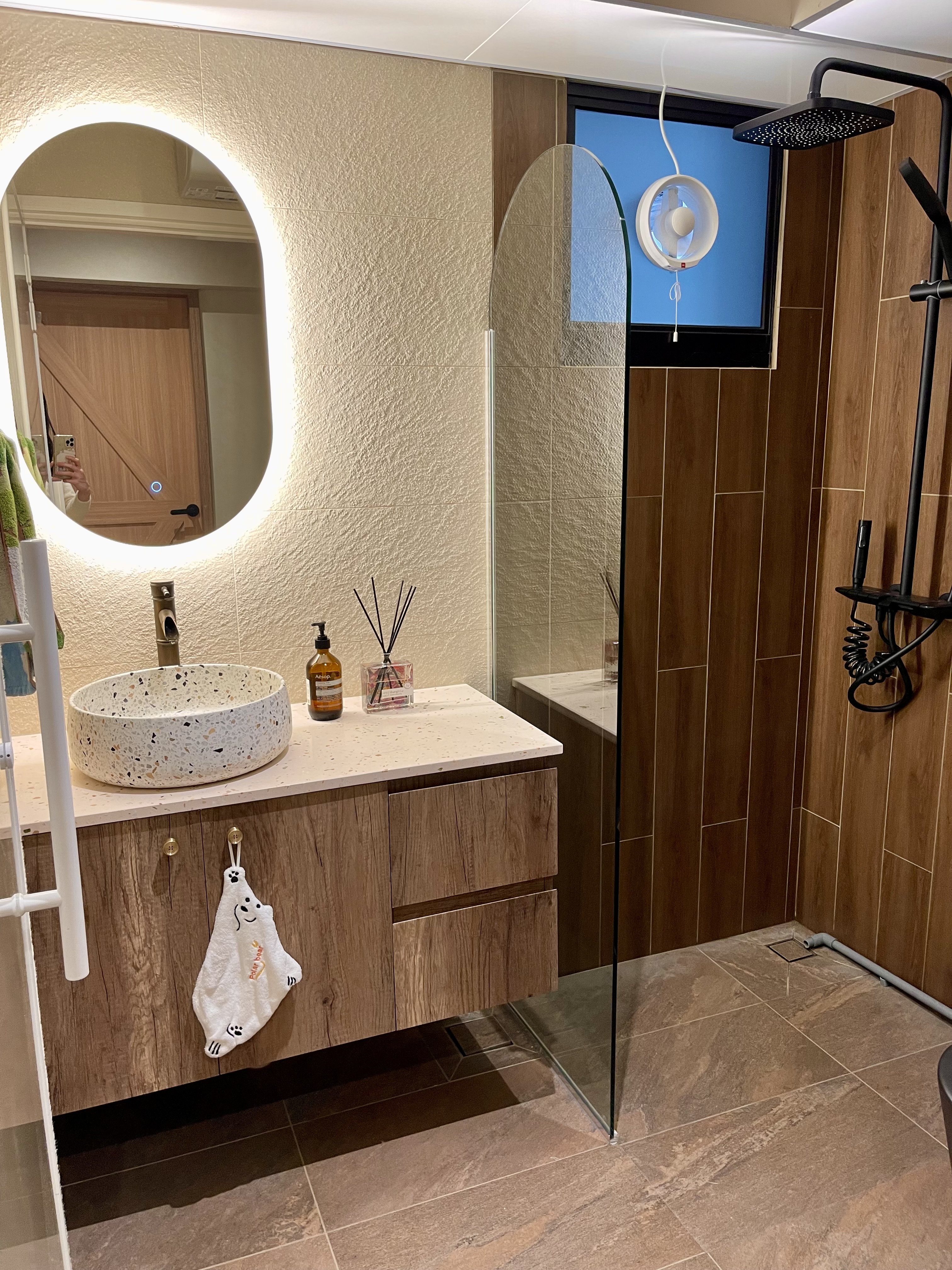 Our Bathroom Sanctuaries: A Concealed Luxe Master Ensuite VS Resort - Round mirror, wooden vanity, speckled sink, white