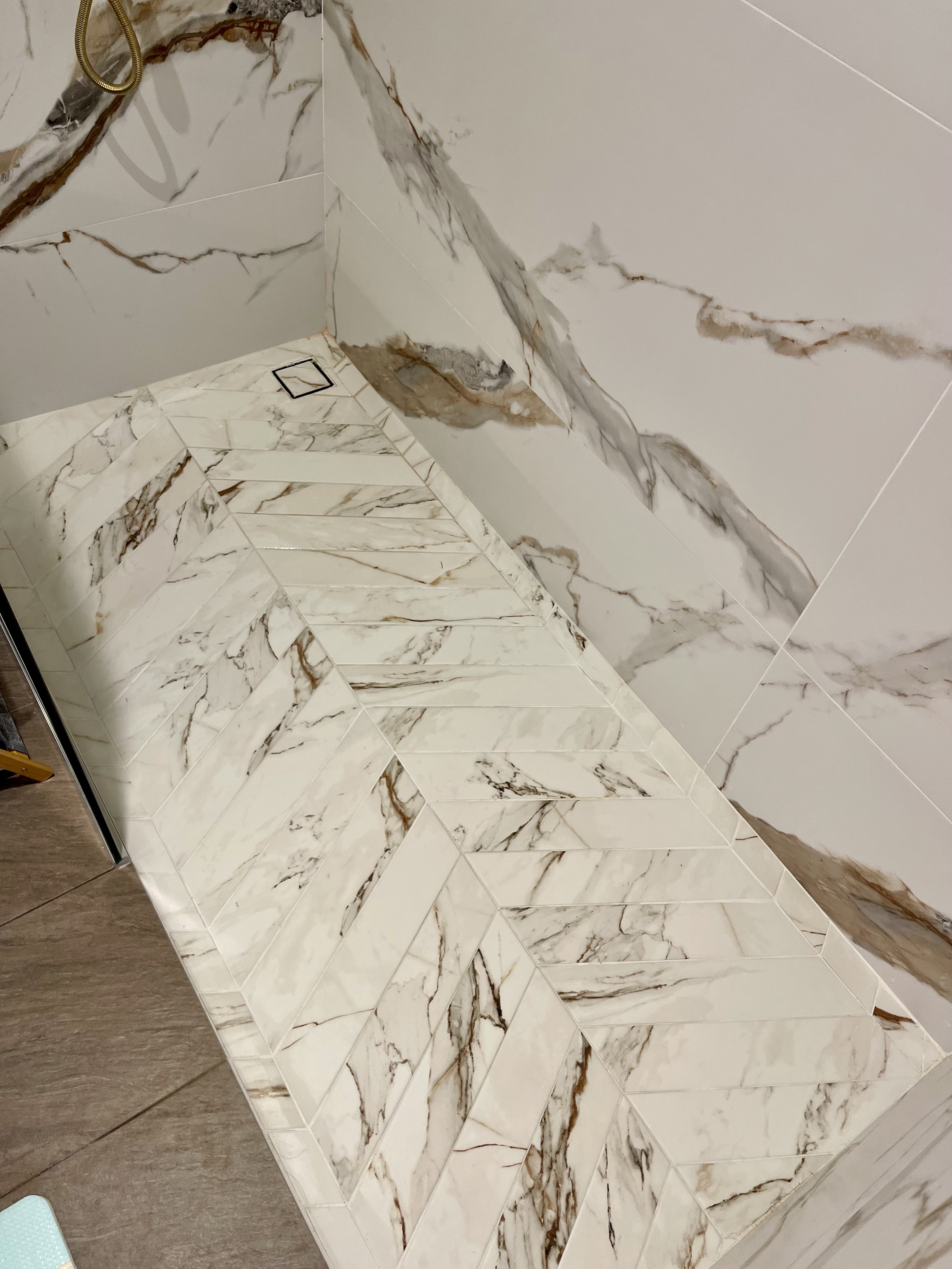 Our Bathroom Sanctuaries: A Concealed Luxe Master Ensuite VS Resort - Marble-patterned tiles, white and gray color scheme