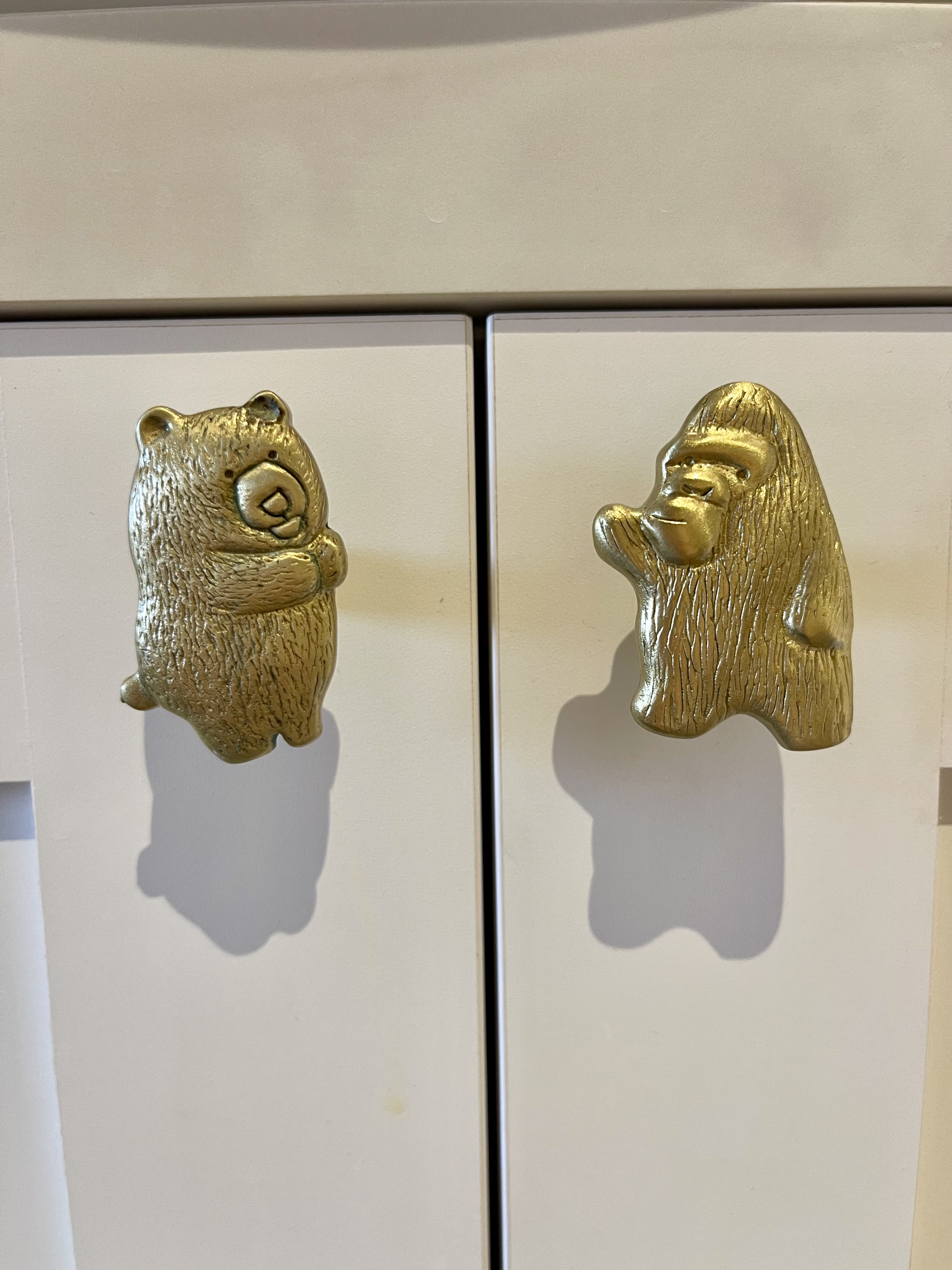 Our Bathroom Sanctuaries: A Concealed Luxe Master Ensuite VS Resort - Gold bear figurines, whimsical design, textured