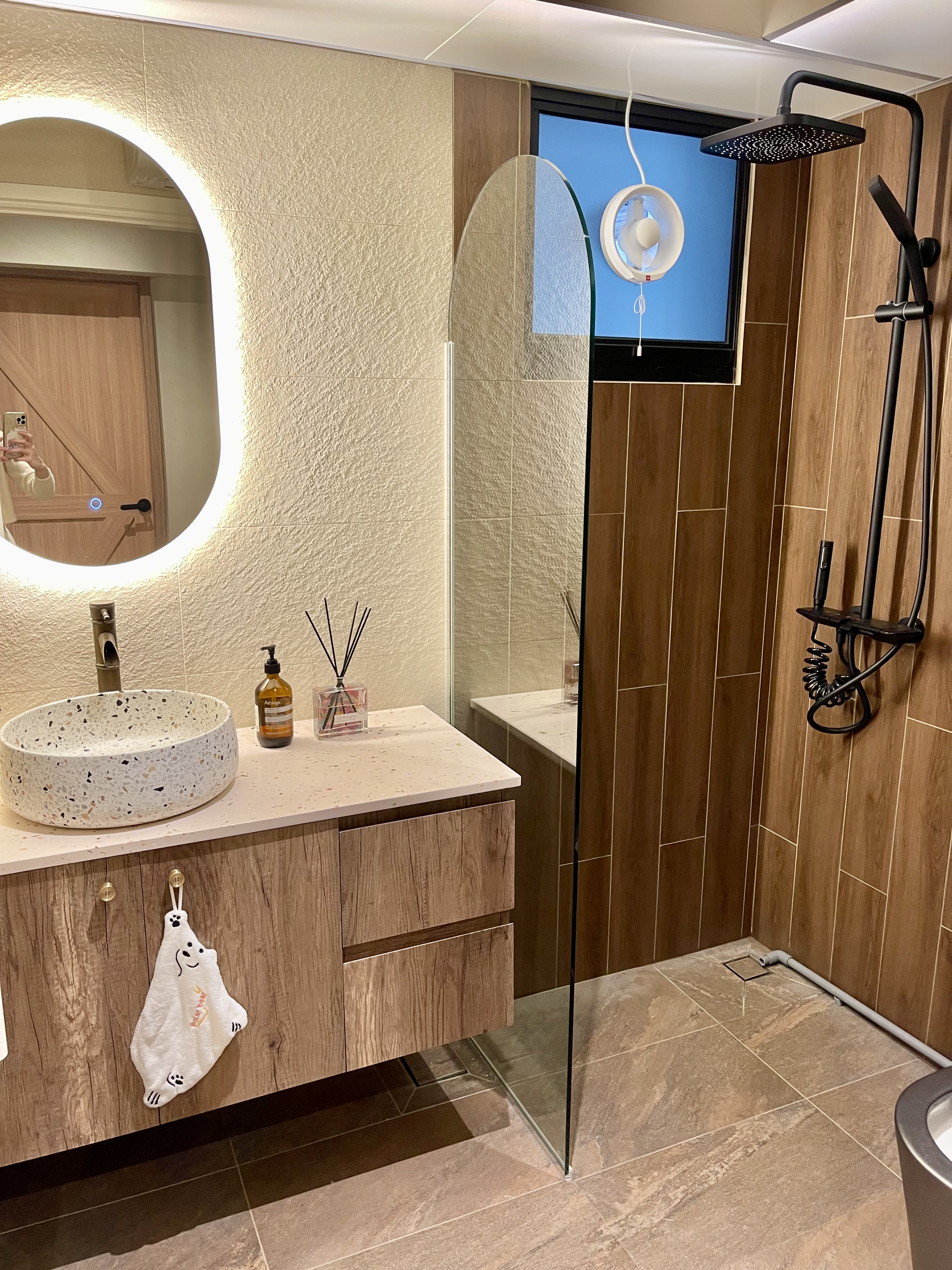 Our Bathroom Sanctuaries: A Concealed Luxe Master Ensuite VS Resort - Bathroom vanity with oval light, wooden cabinets