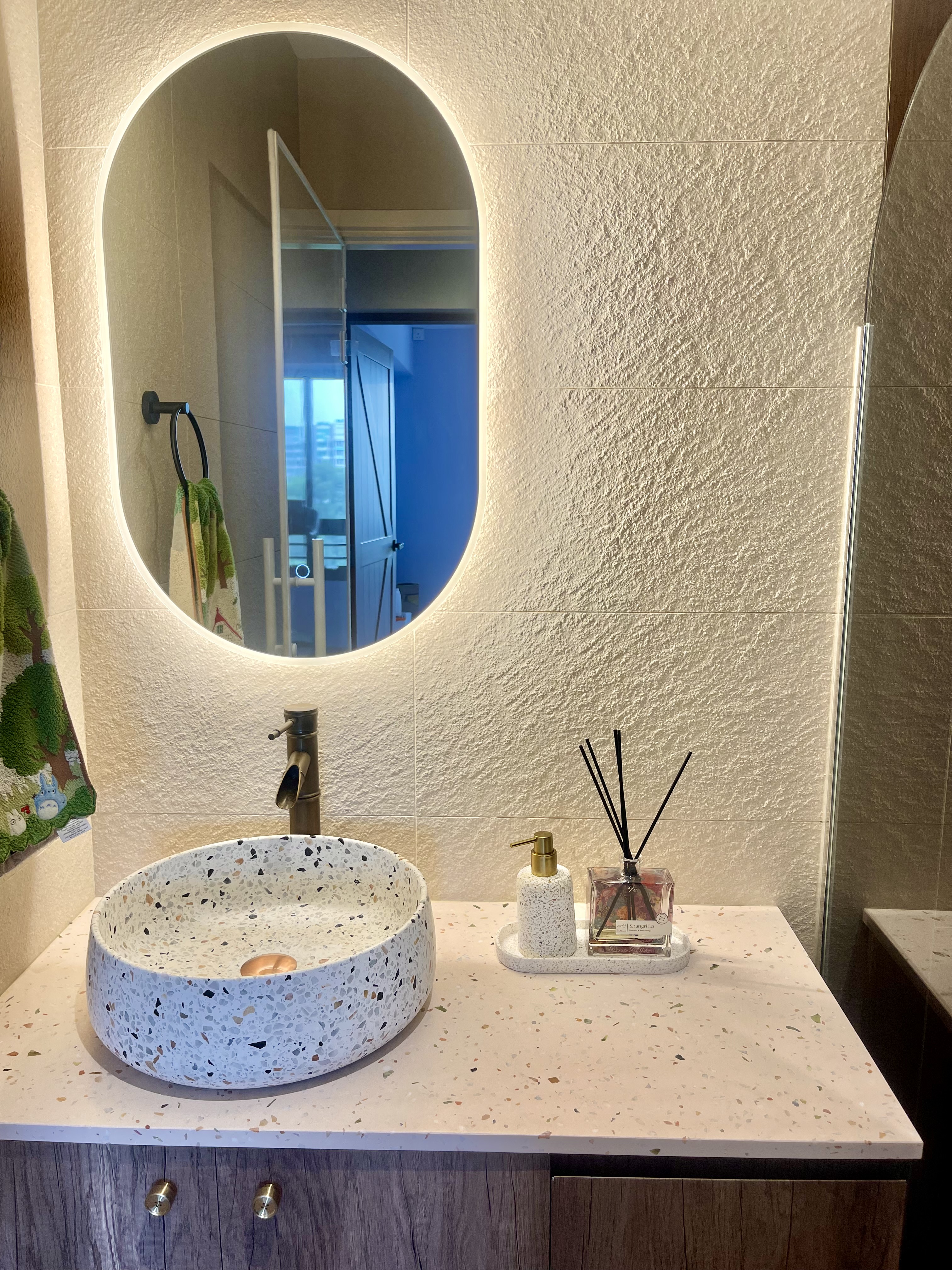 Our Bathroom Sanctuaries: A Concealed Luxe Master Ensuite VS Resort - White speckled basin, oval mirror, textured wall