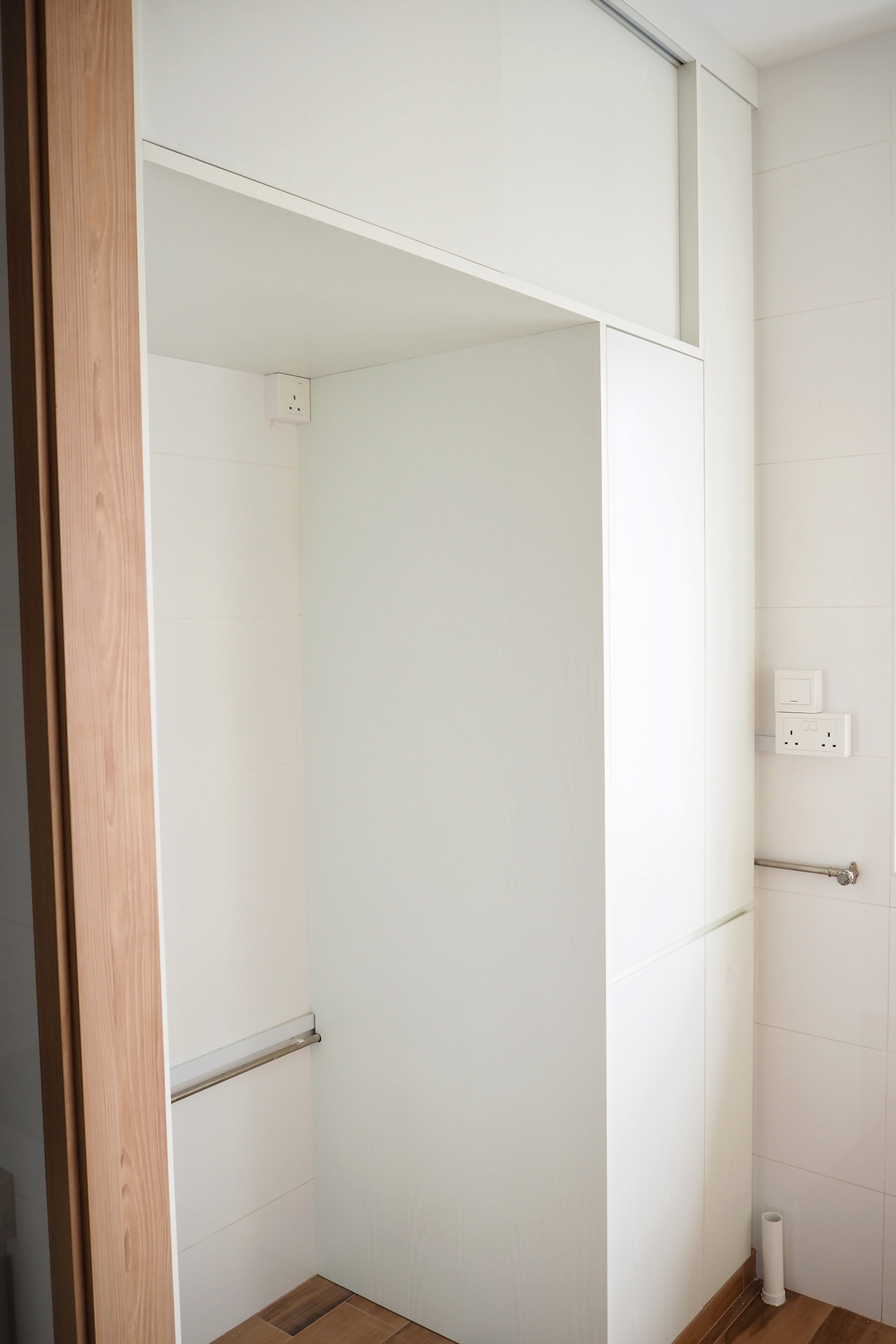 Our top renovation decision to tackle dust and clutter - White bathroom cabinet, minimalist design, wooden door frame, tiled