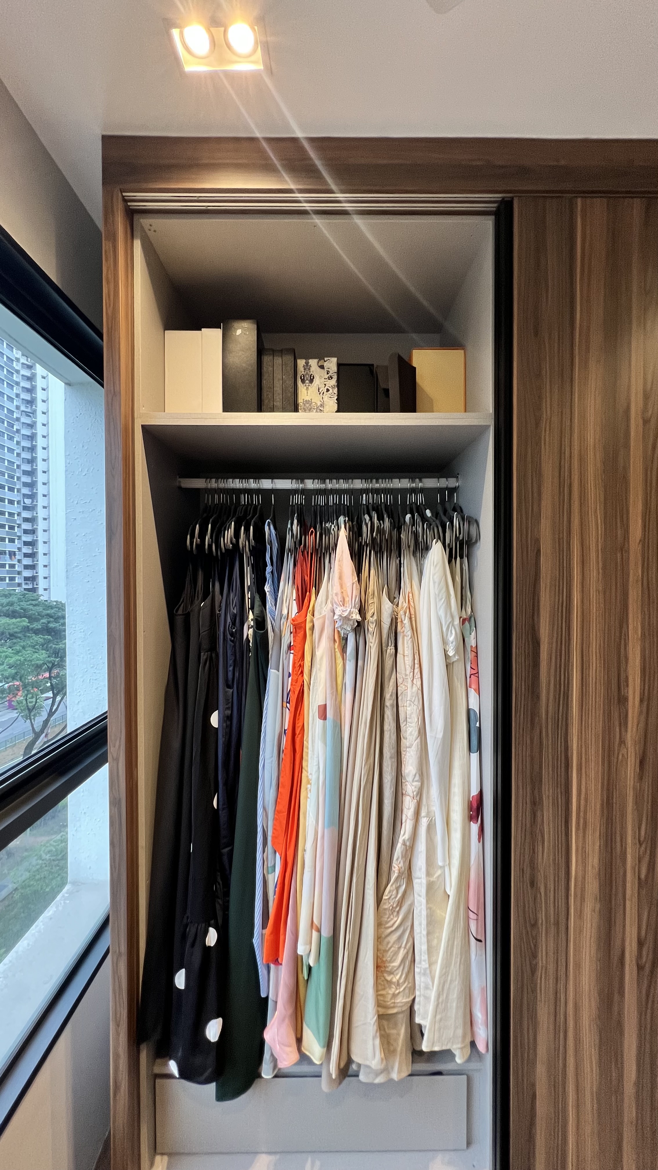 Transforming Spaces: From Wardrobe Sanctuary to Workout Haven - Wooden wardrobe, neatly organized clothes, multi-colored