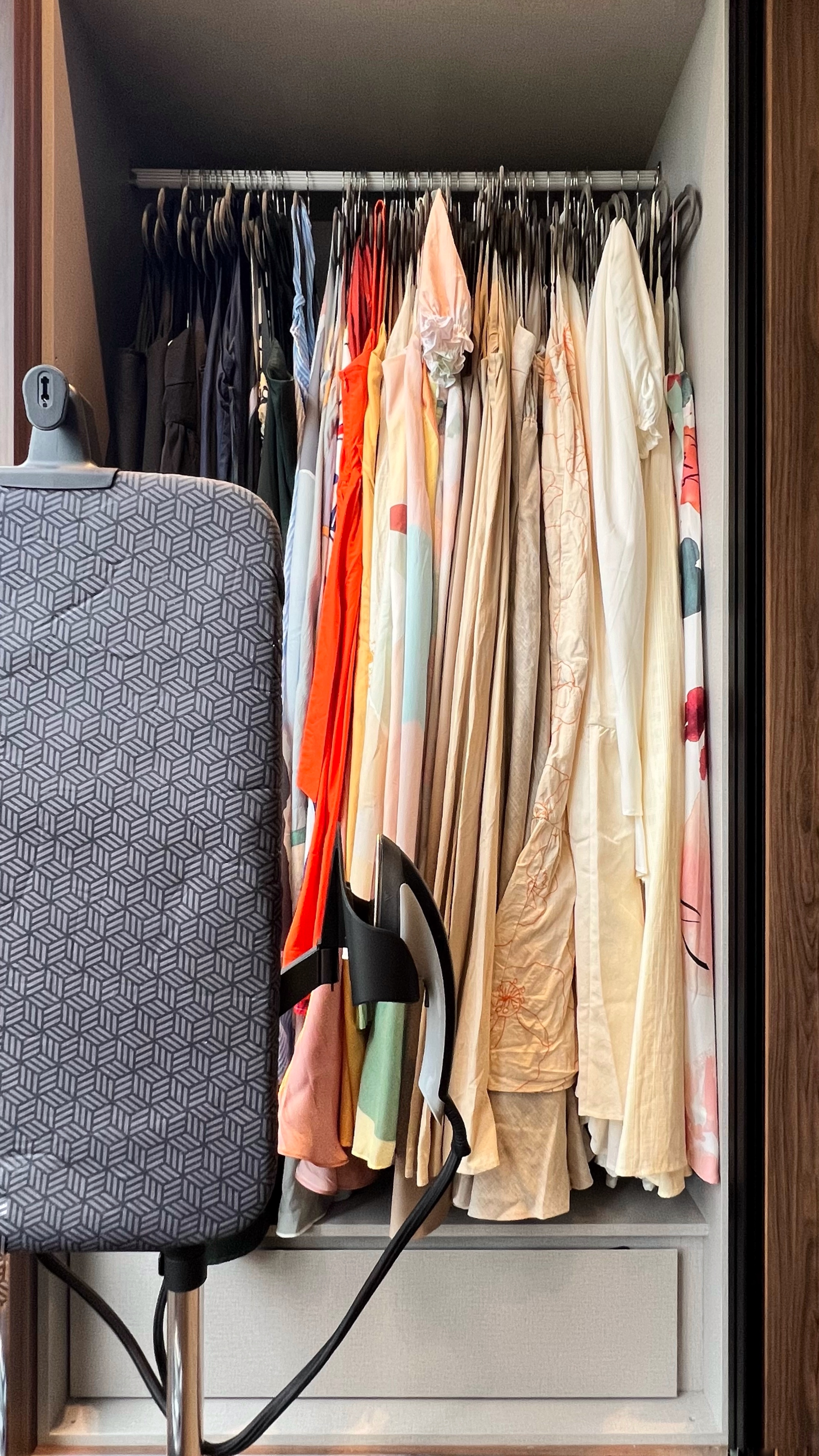Transforming Spaces: From Wardrobe Sanctuary to Workout Haven - Patterned suitcase, hanging clothes, diverse fabrics