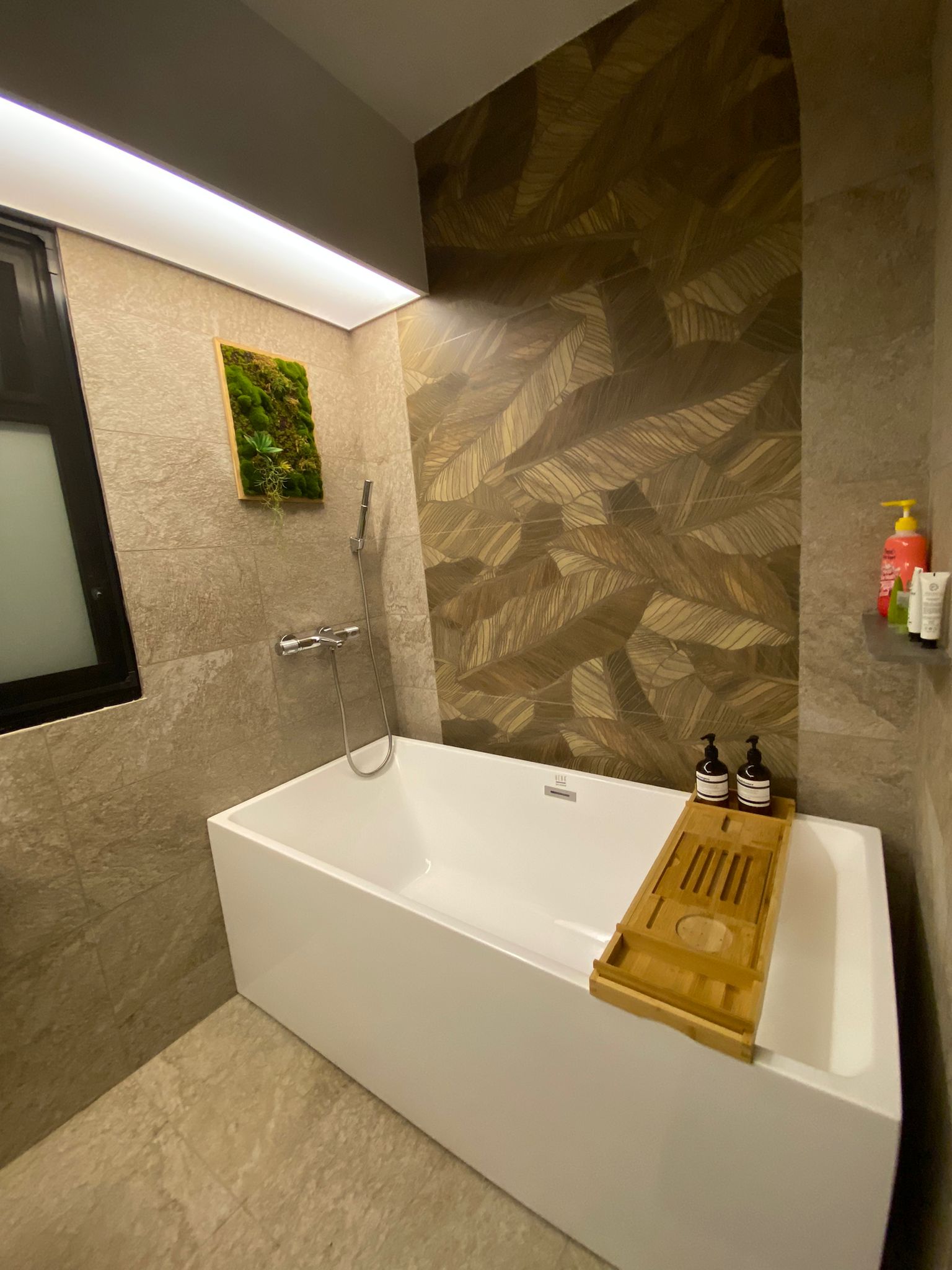 Our bathrooms: Resort-style relaxing sanctuaries - Bathtub with modern design, beige tiles, sleek fixtures, natural leaf