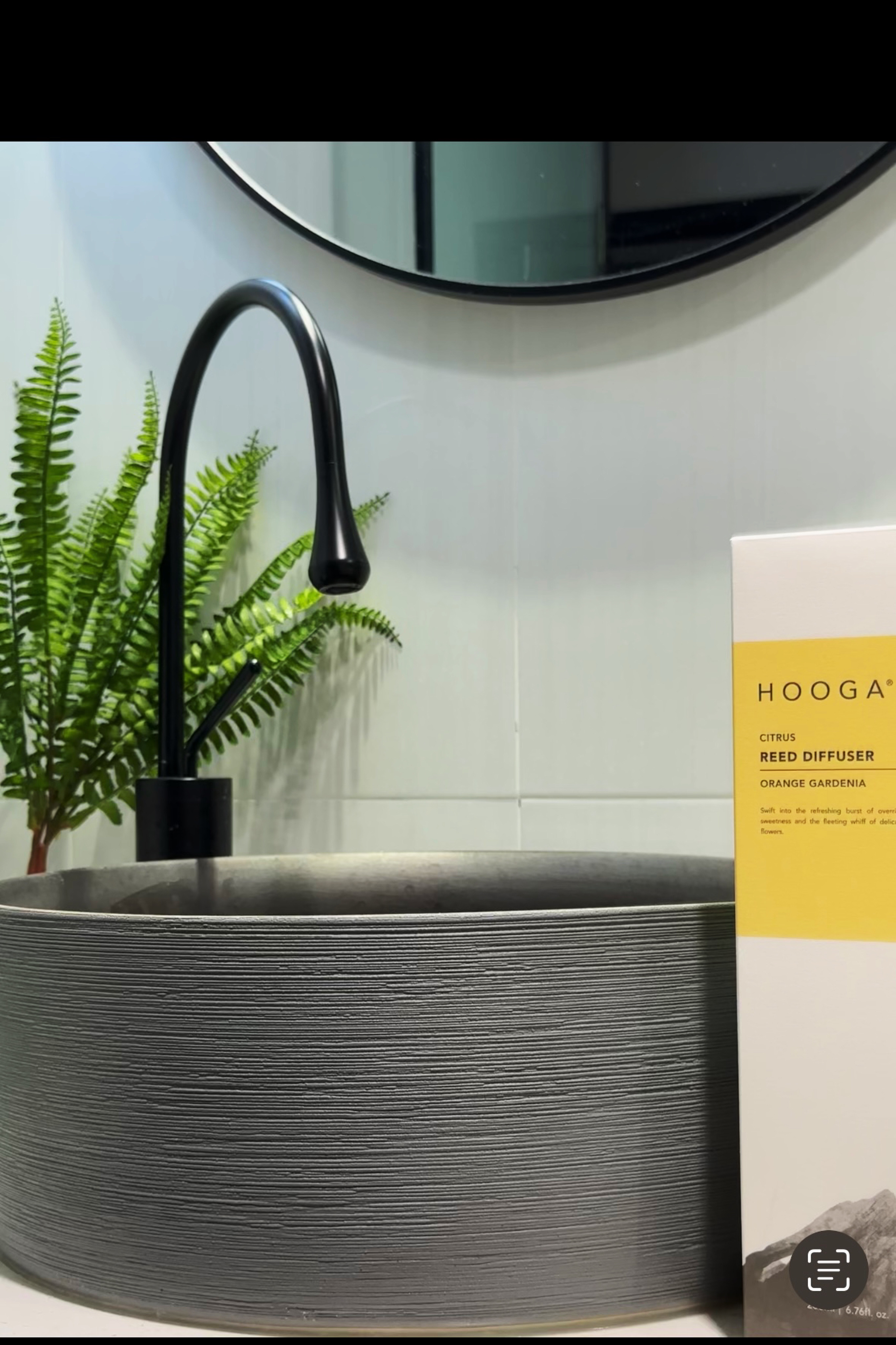 A modern, cozy toilet that invites and motivates. - Modern bathroom sink, sleek faucet, black curved faucet, minimalist