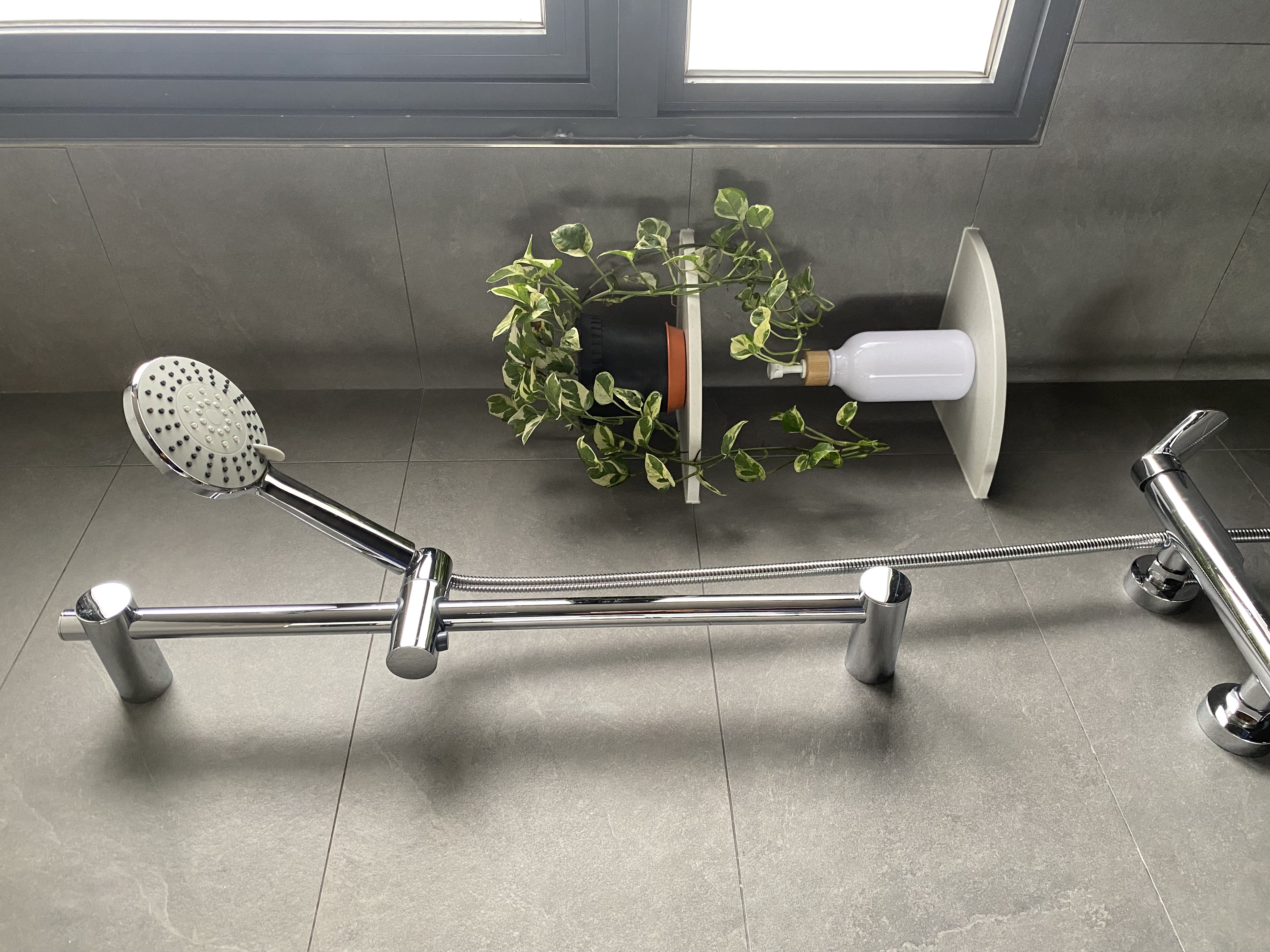 Moody and textured bathrooms in 50 shades of grey - shower head, modern design, metallic finish, plant in pot, gray tiled