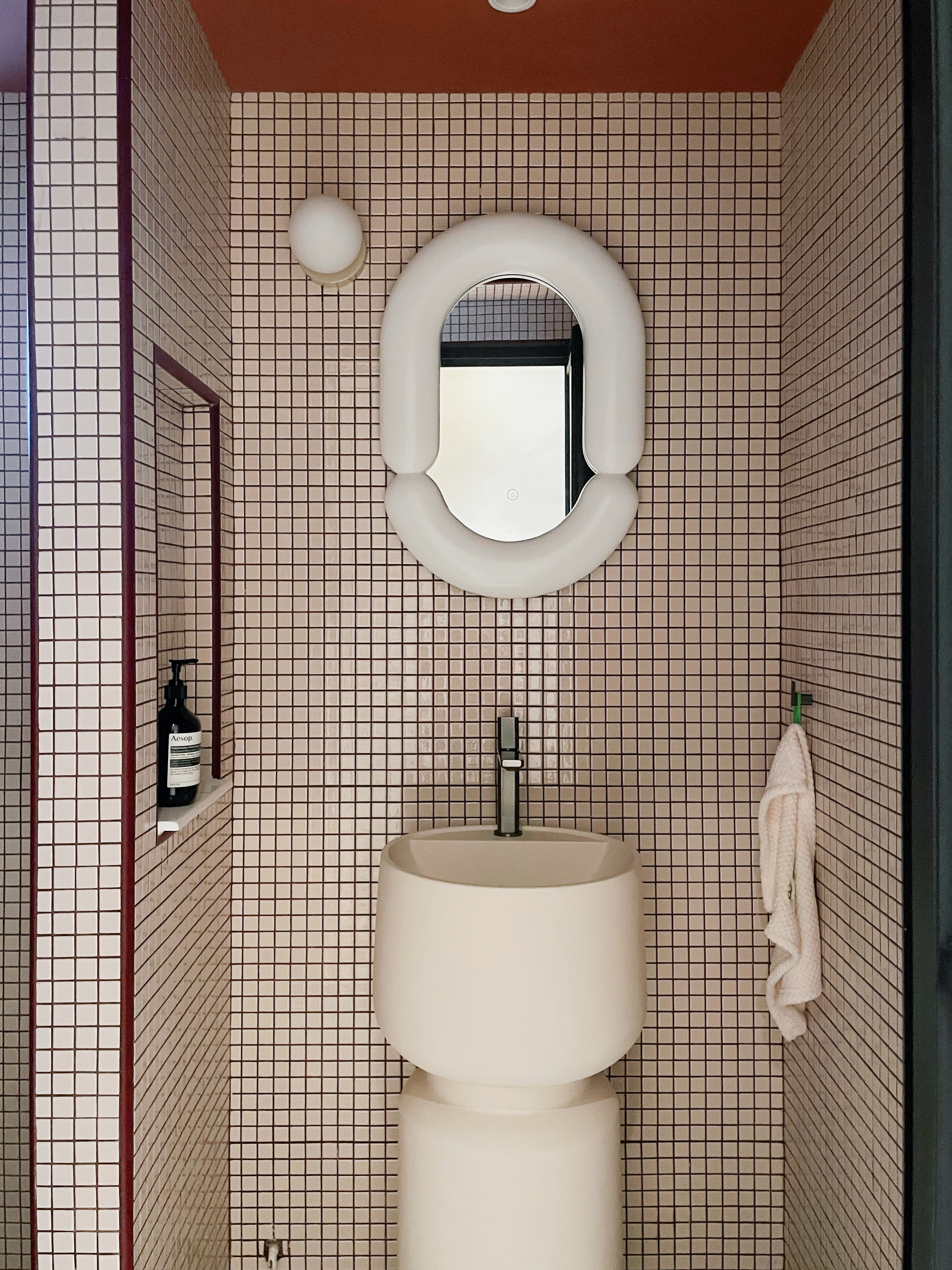 Mosaic Bathroom: Bold and Quirky with Retro Vibes and Modern Flair - White bathroom vanity, beige tiled walls, oval mirror
