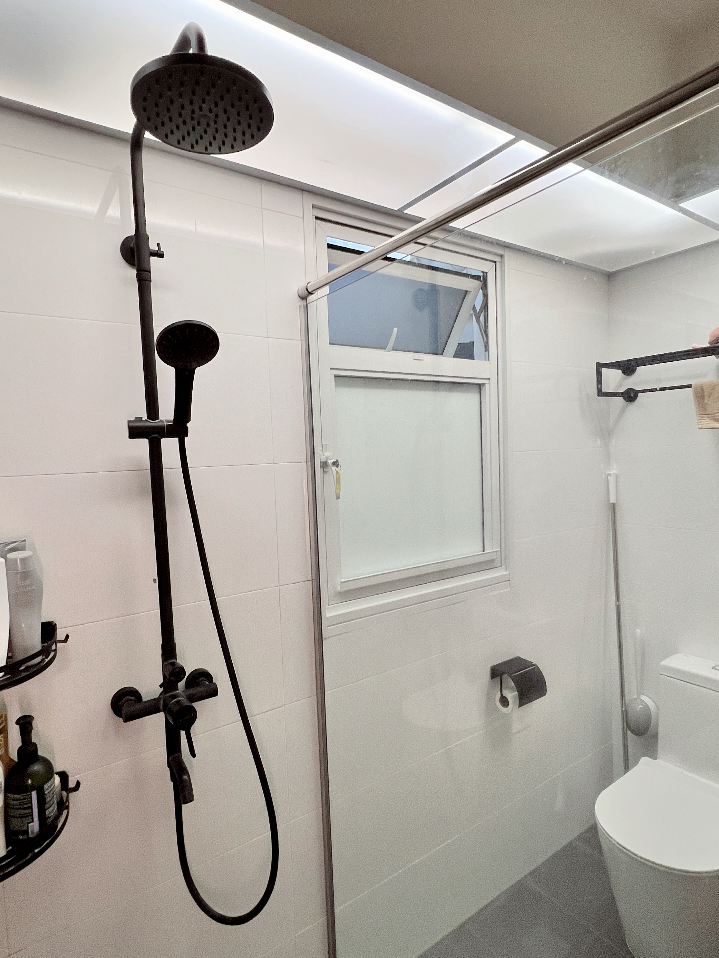 Budget Toilet Renovation Under $1K!! 🛀🏼 - Black showerhead and handheld shower, white tiled walls, modern bathroom design