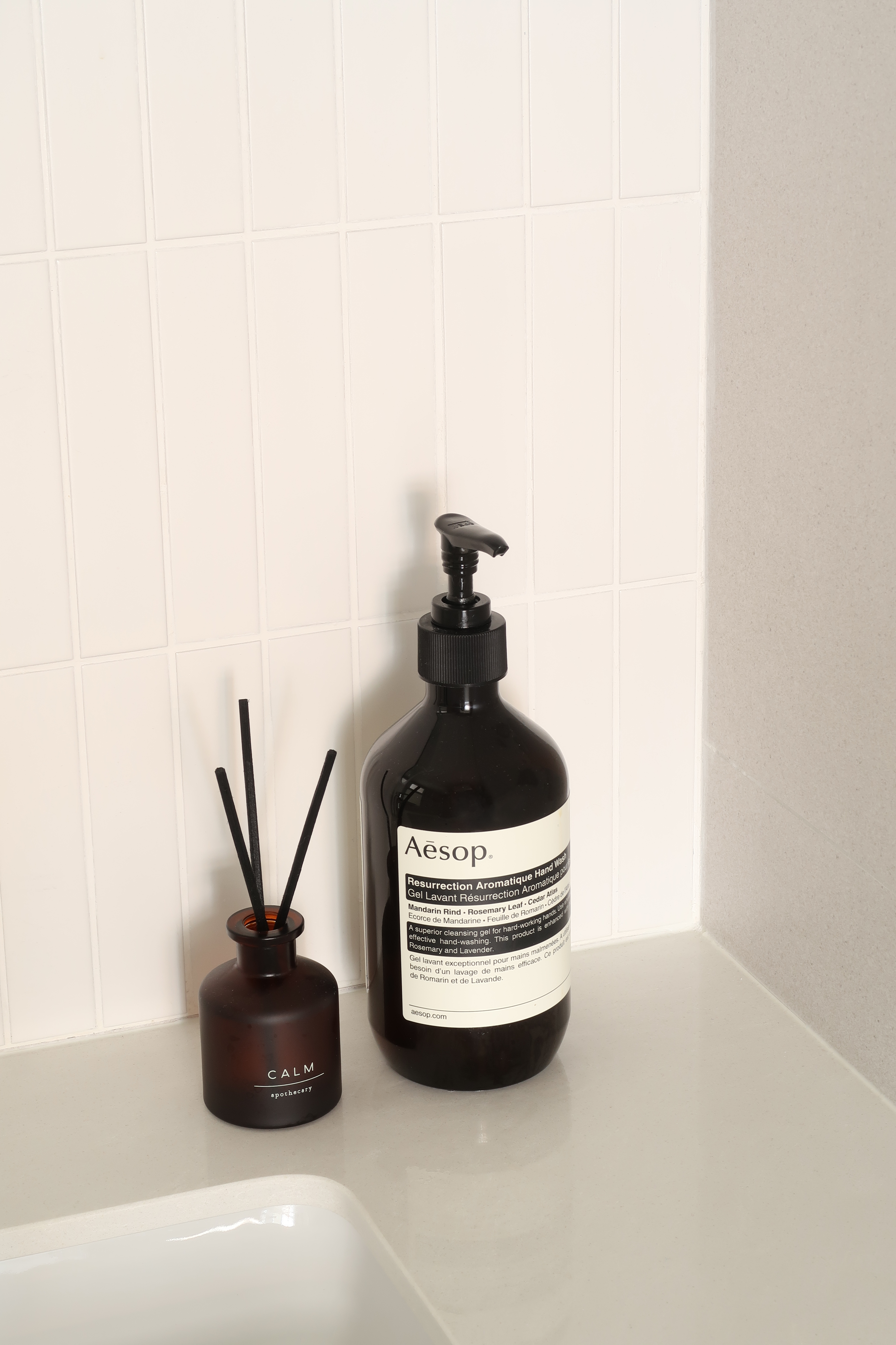 Guest Bathroom: Clean Lines and Subway Tiles - White tiled wall, bathroom counter, Aesop hand wash bottle, black pump