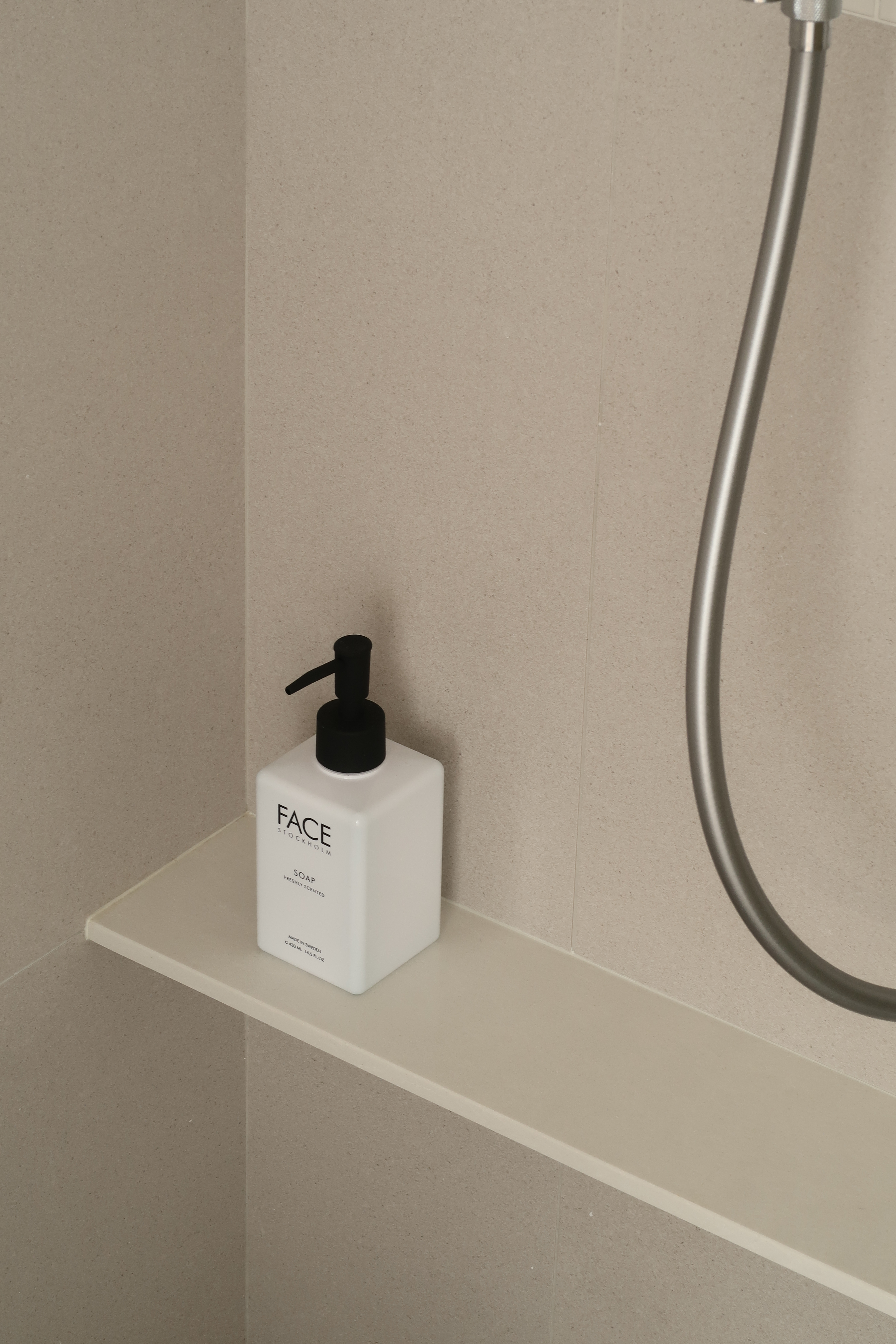 Guest Bathroom: Clean Lines and Subway Tiles - White soap dispenser with black pump, beige tiled wall, minimalist bathroom