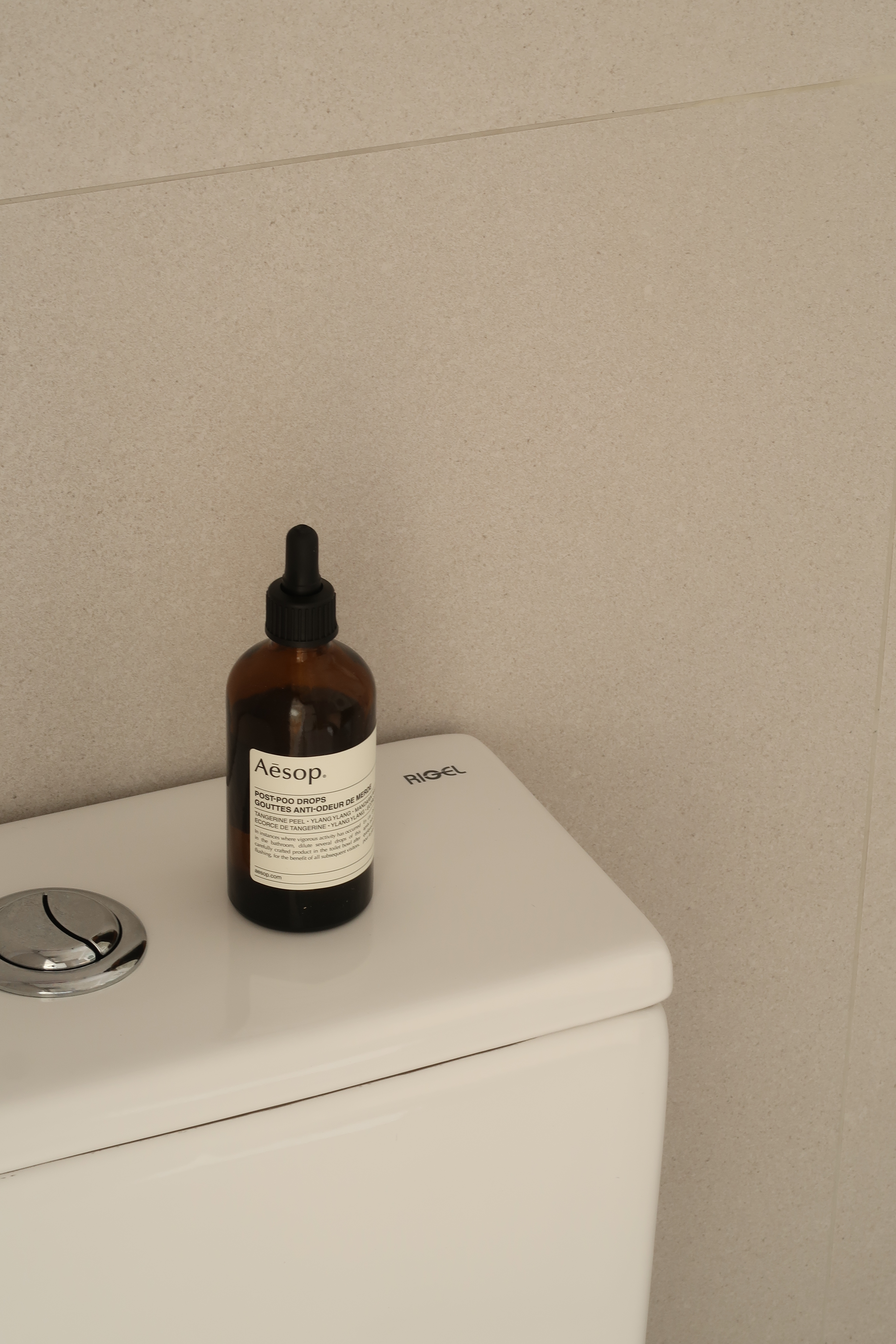 Guest Bathroom: Clean Lines and Subway Tiles - Bathroom sink, toilet, white toilet tank, bottle of Aesop post-poop drops