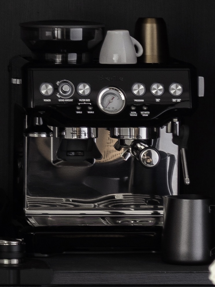 Non-regrets: best home investment decisions!  - Black espresso machine, sleek design, control panel, power button, grinder