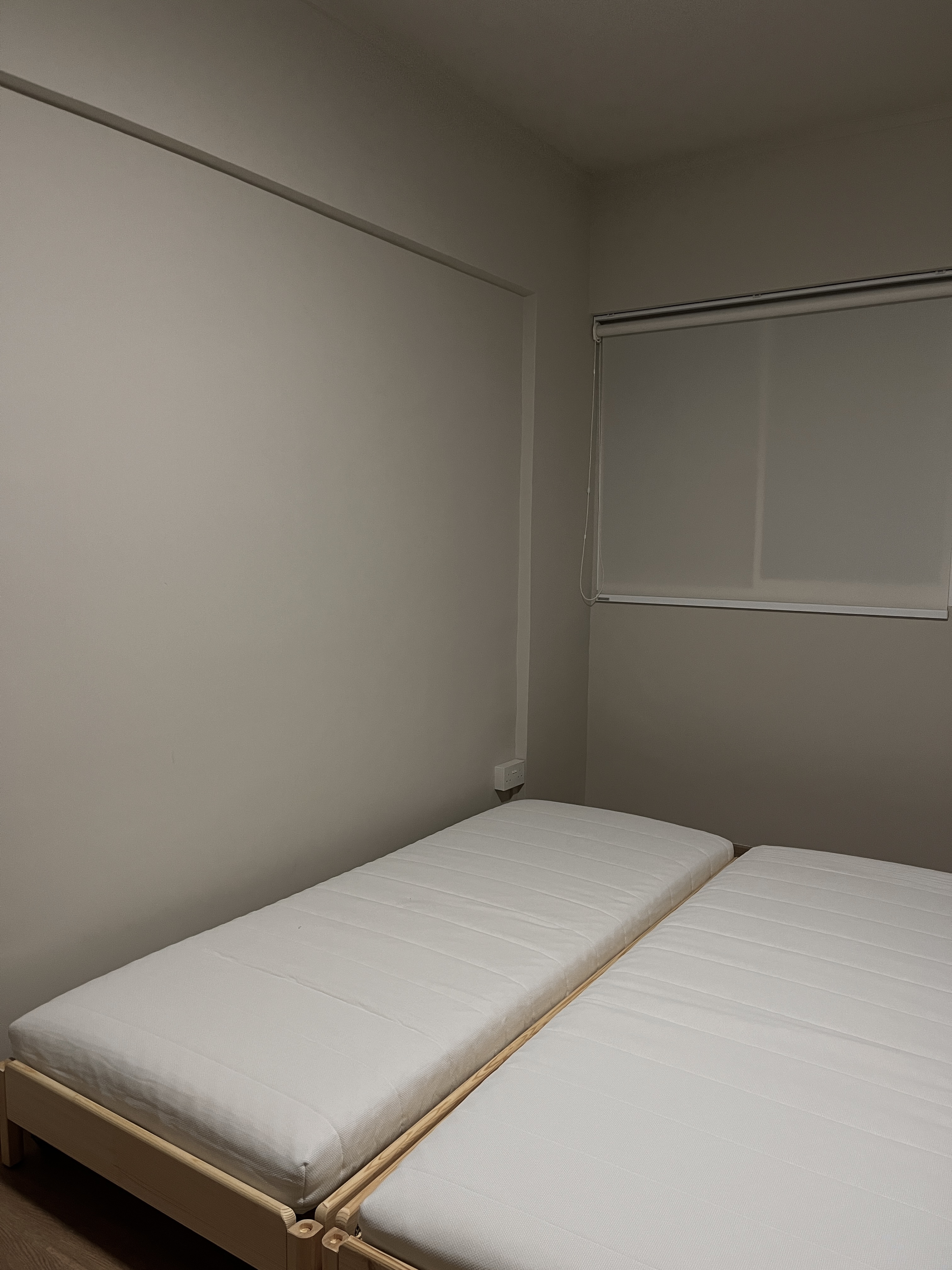 Creating the Perfect Guest Room: A Blend of Comfort and Style - Minimalistic bedroom with two neatly made beds, White bedding