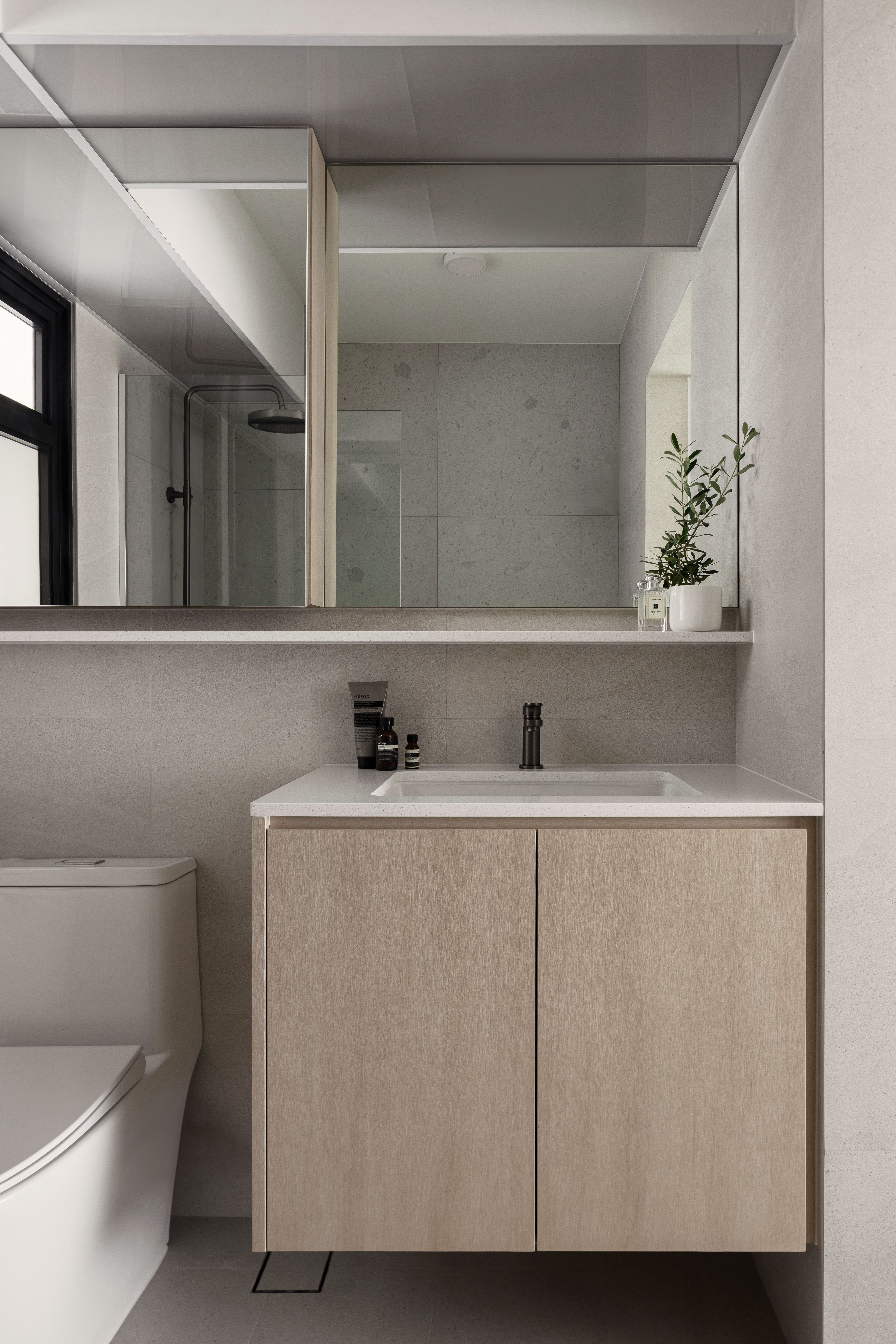 The Bathroom: Everyone’s Throne Room - Modern minimalist bathroom, sleek vanity, floating shelf, large mirror, light-colored