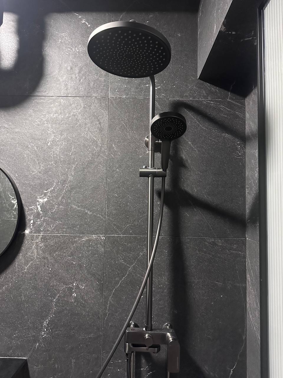 Modern Elegance in the Bathroom: A Blend of Style and Function - Showerhead with multiple nozzles, sleek black fixtures