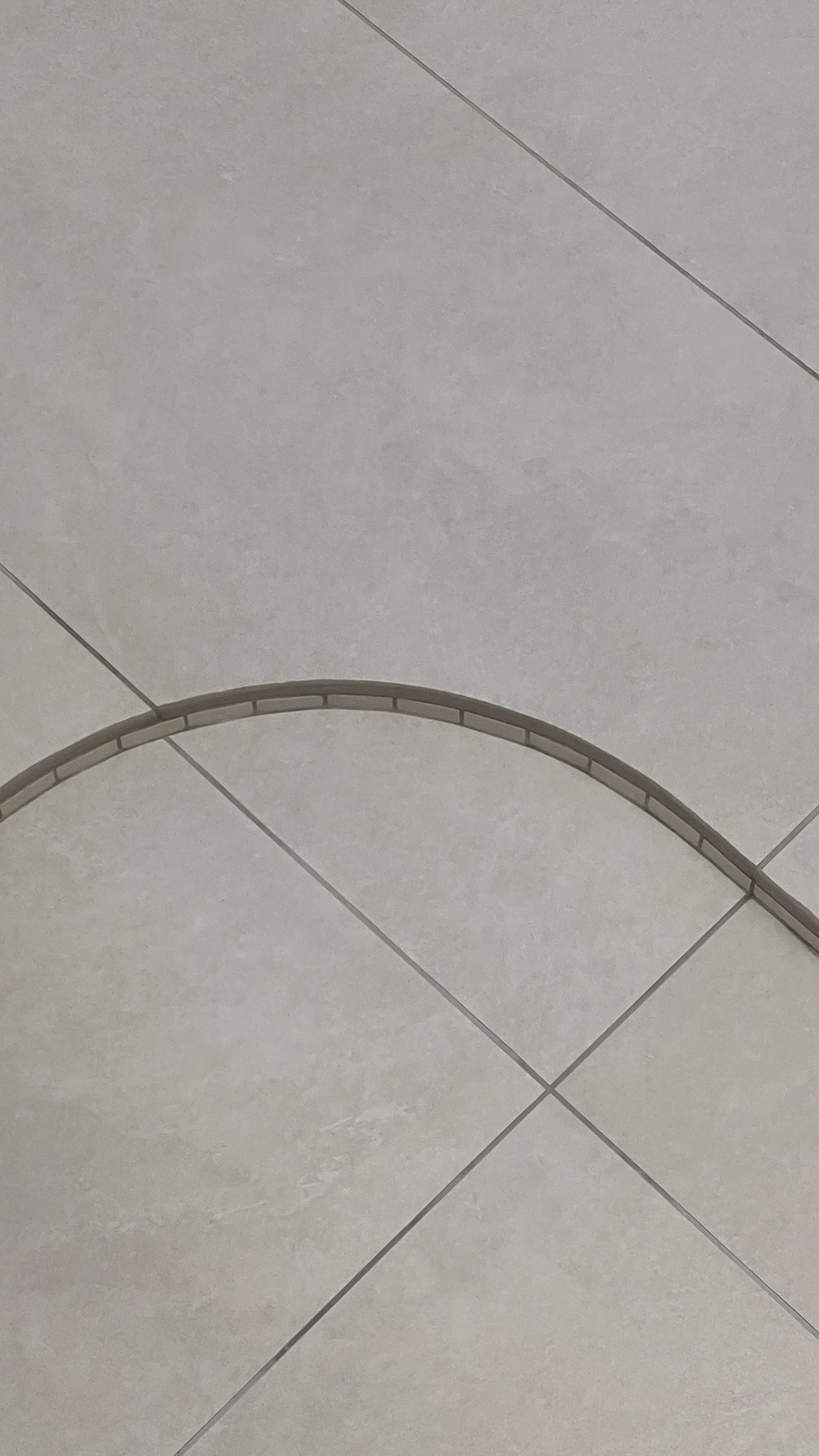 The Bathroom: Everyone’s Throne Room - Light gray tiled floor with subtle texture, Symmetrical design featuring diagonal