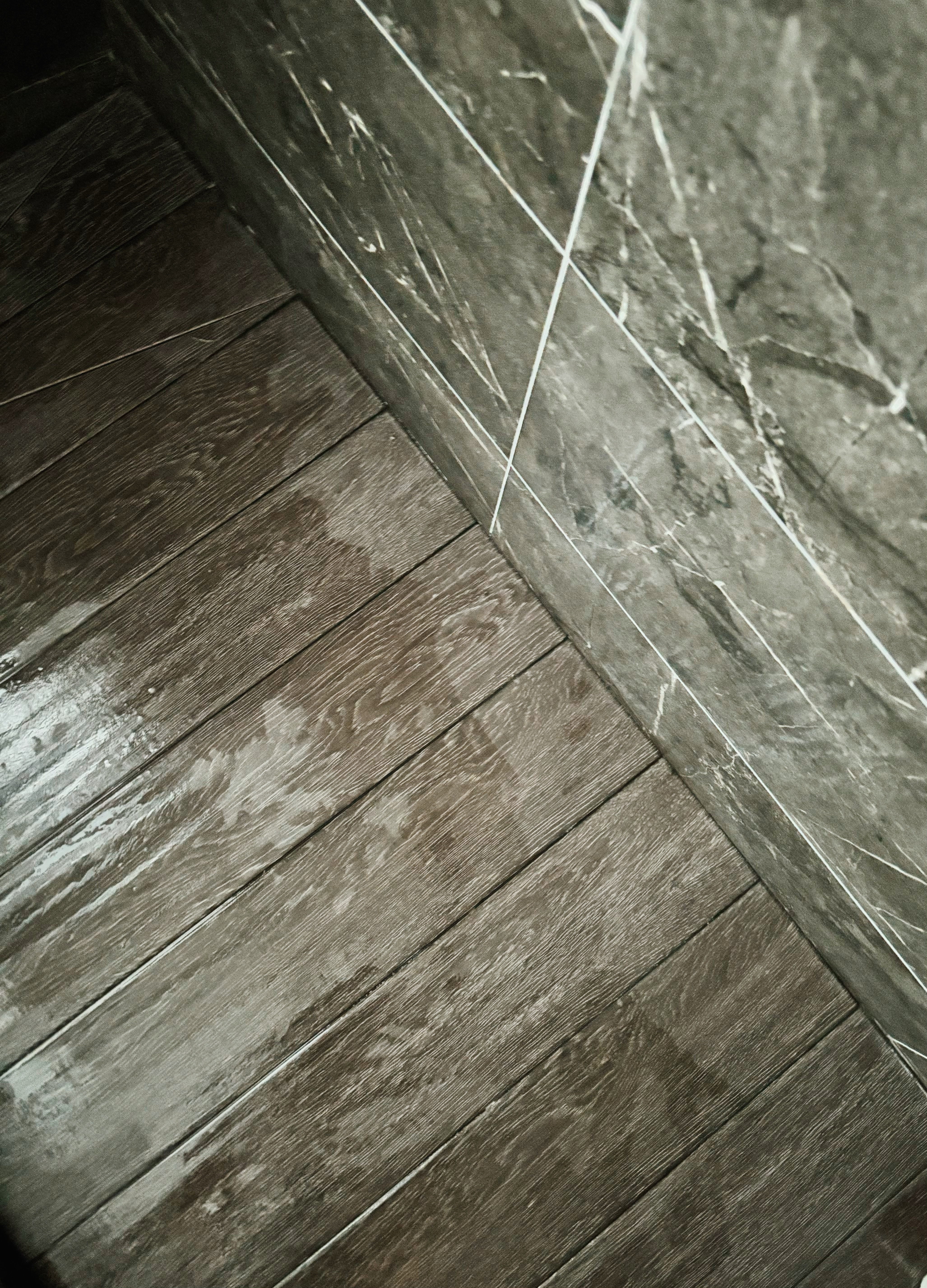 Refined and Modern: Our Master Bath Scene - Dark wooden floor, contrasting with gray marble wall, weathered texture, natural