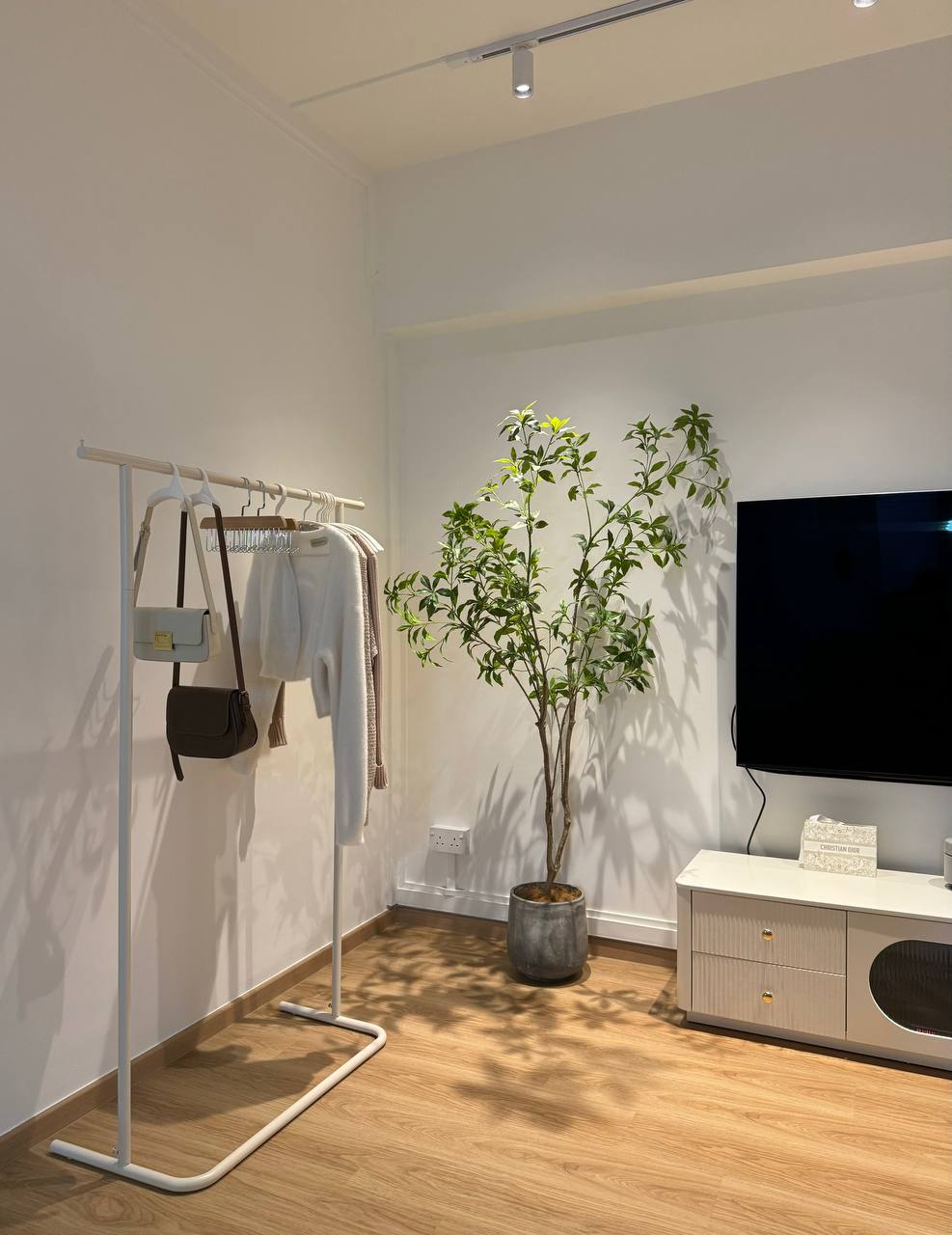 Farmhouse Living Room - our favourite part of the house  - White clothing rack, hanging garments, white coat, black purse