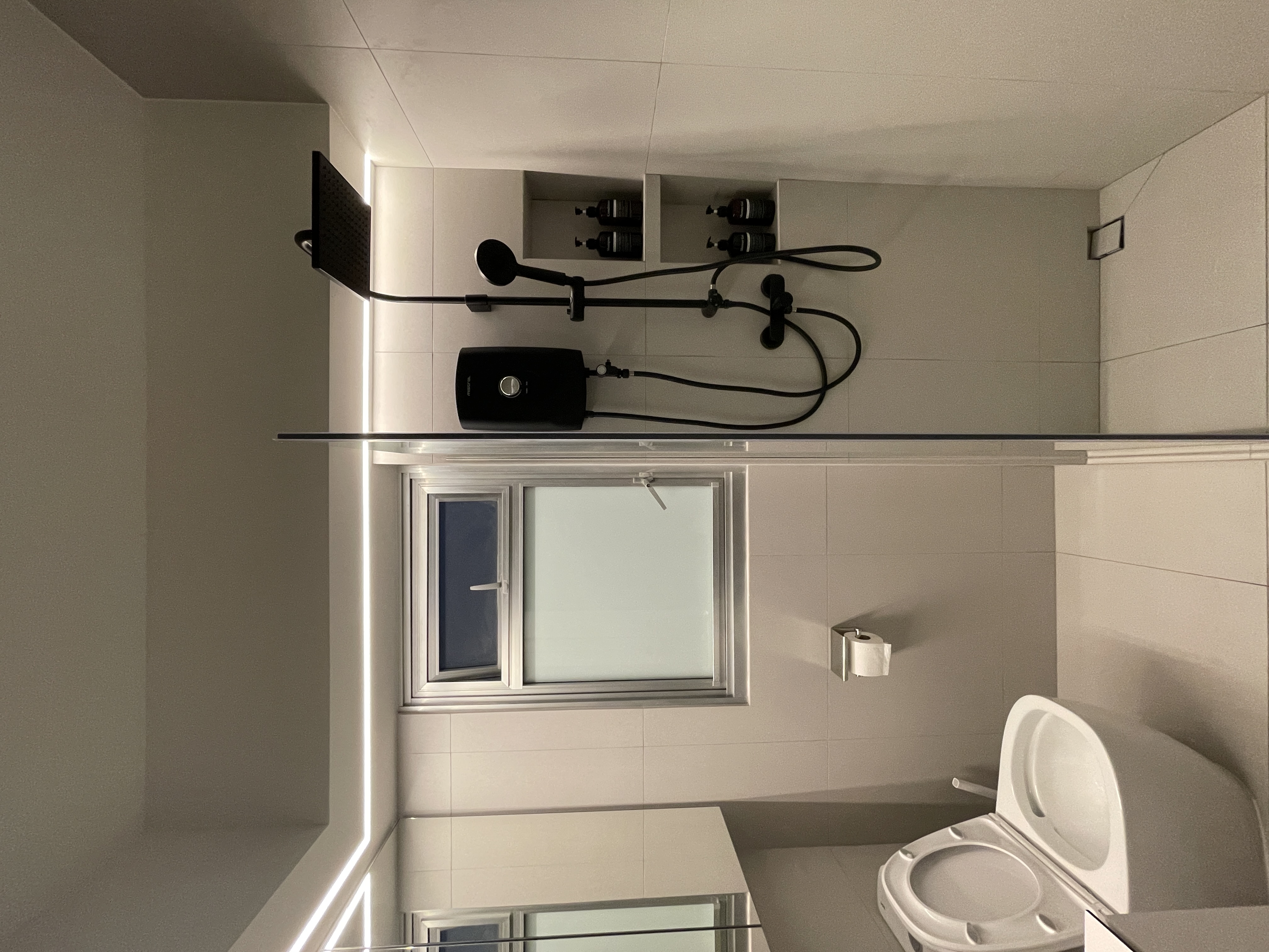 Elevate Your Space: Hotel-Inspired Bathrooms Transformation - Modern minimalist bathroom, sleek design, tiled walls, large