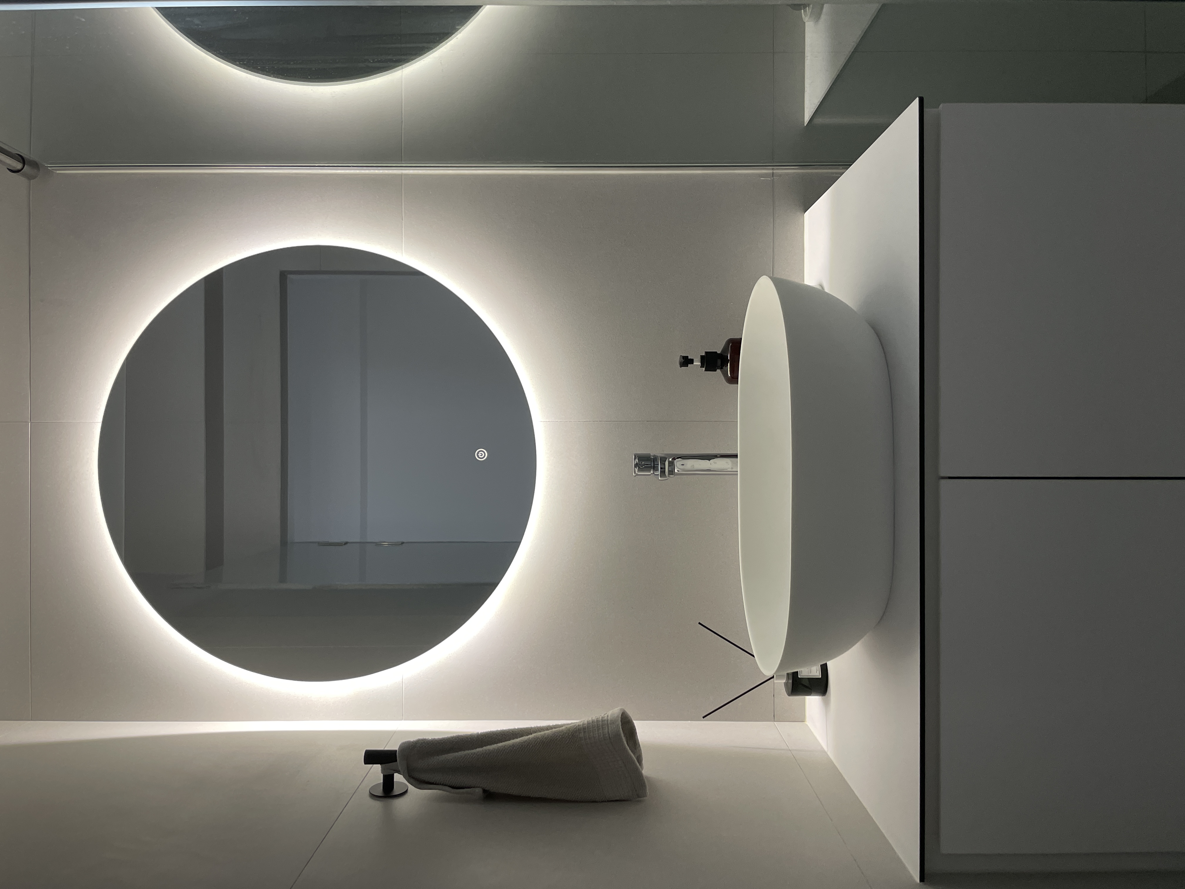 Elevate Your Space: Hotel-Inspired Bathrooms Transformation - Modern minimalist bathroom, sleek design, circular mirror