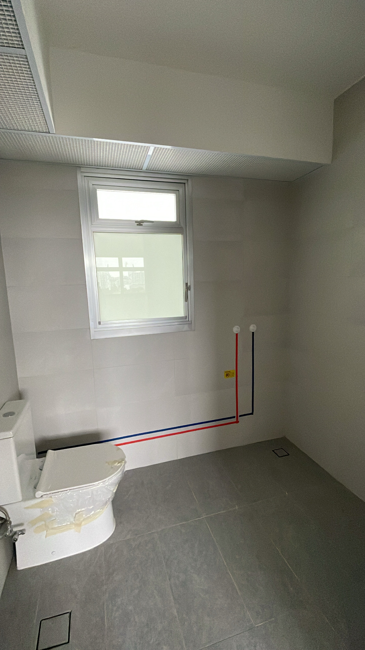 Elevate Your Space: Hotel-Inspired Bathrooms Transformation - Modern bathroom with gray tiles, white toilet, red and blue