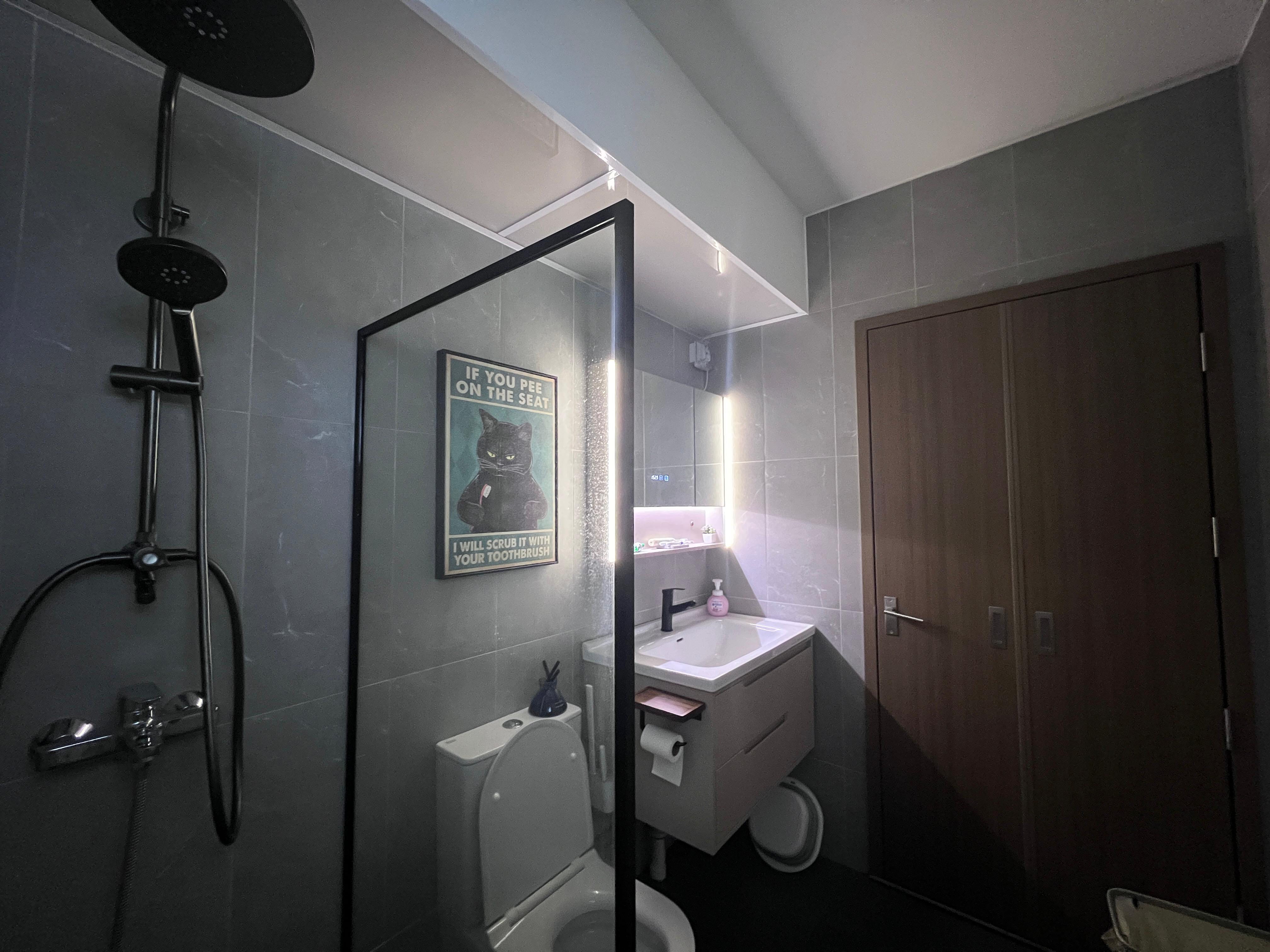 Simple and cost saving toilet - Grey tiled bathroom, modern design, black showerhead, black toilet, wooden door, mirror with