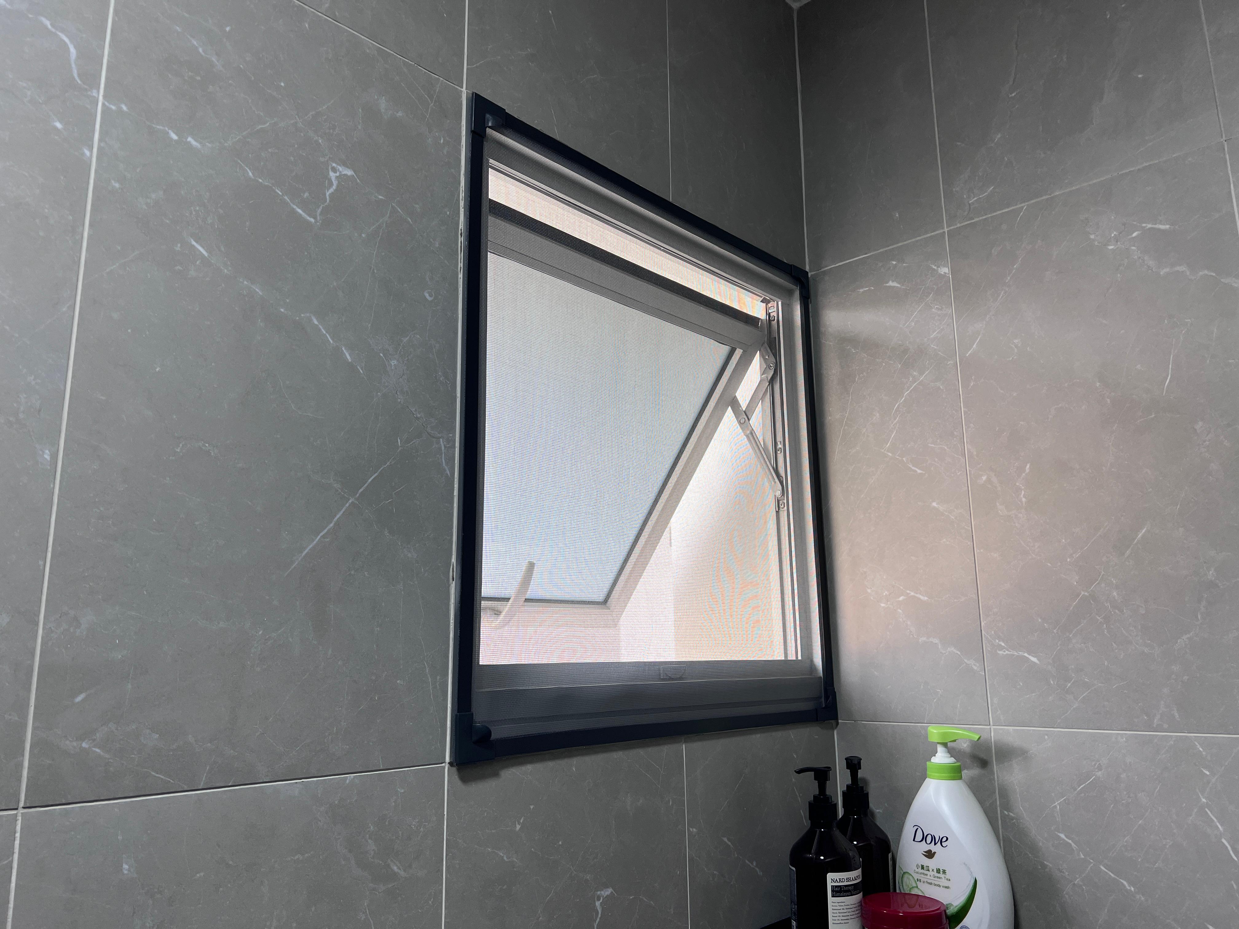 Simple and cost saving toilet - Grey marble tiles, window frame, black frame, bathroom vanity, toiletries, skincare products