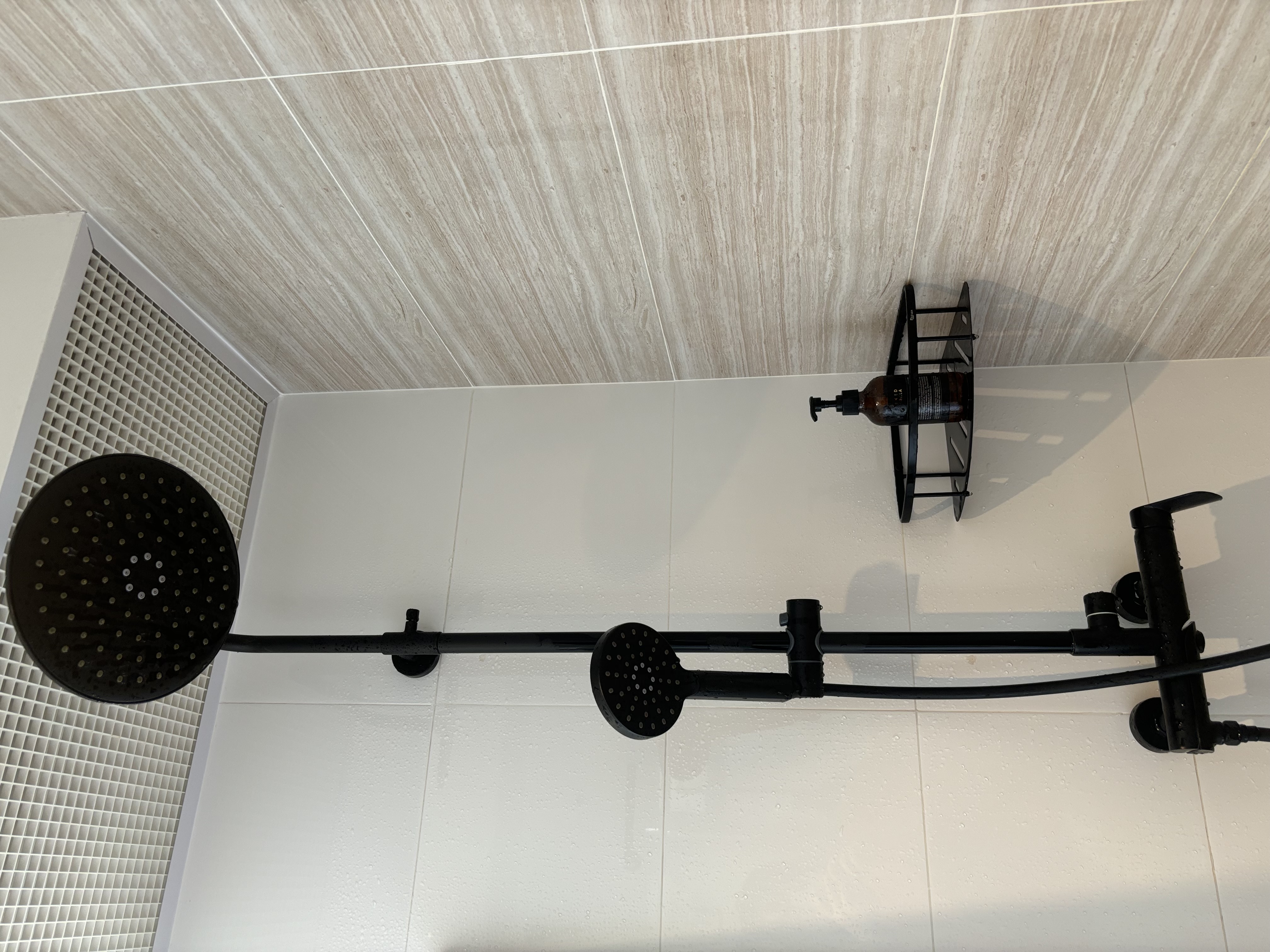 Minimal Bathroom without Breaking the Bank - Floor drain, showerhead, tiled wall, modern design, white tiles, water droplets