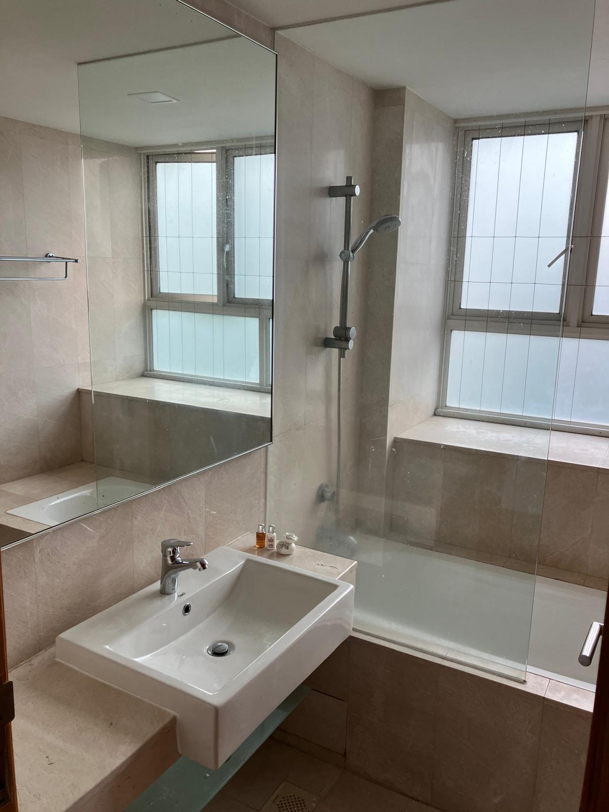 We had a bathtub but dumped it! 🛁 - White bathroom sink, mirror, beige tiles, modern design, large mirror, glass shower