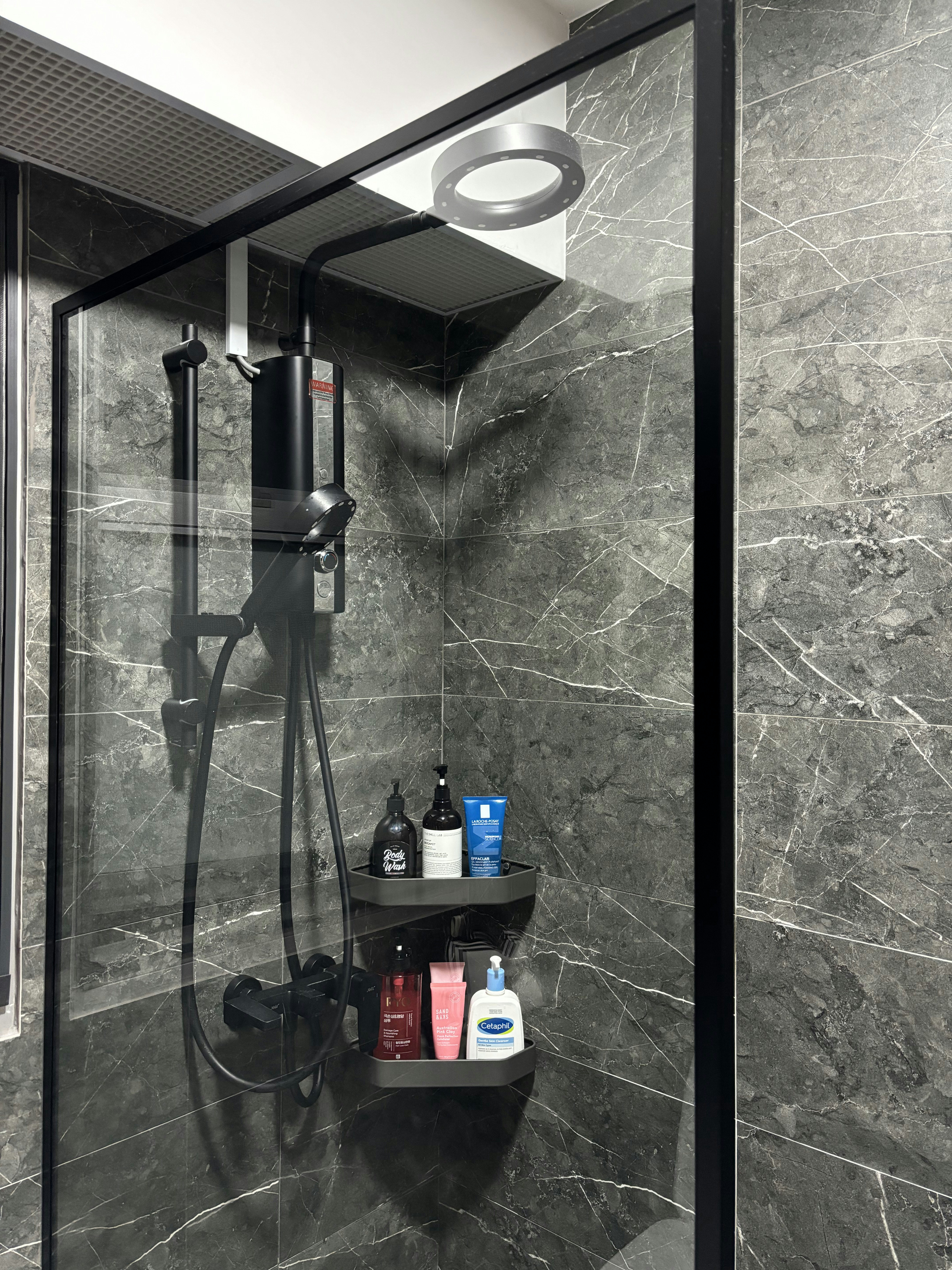 Refined and Modern: Our Master Bath Scene - Shower enclosure with glass doors, black frame, marble walls, black showerhead