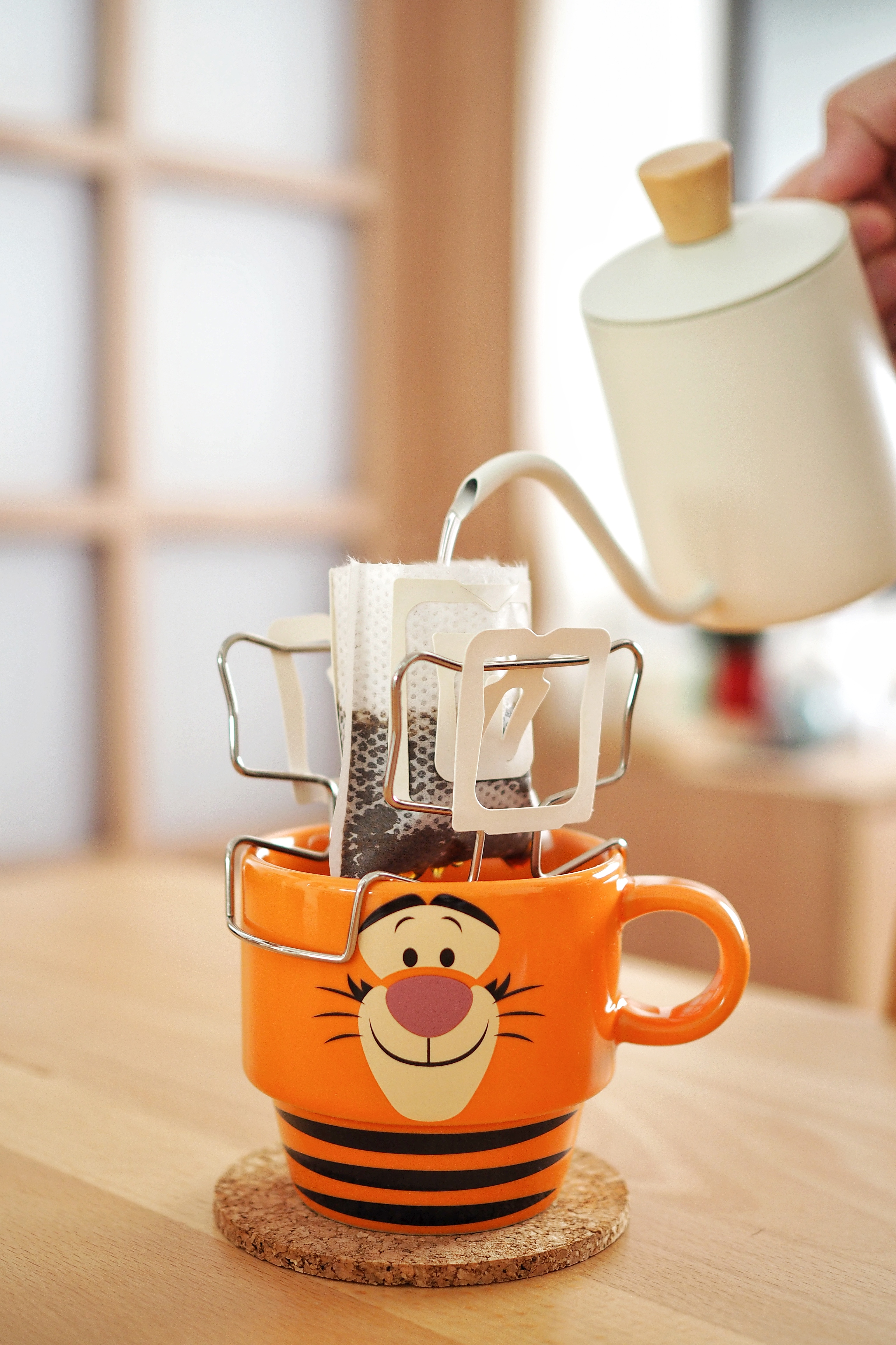 Weekend Mornings with Gacha Coffee, K-Dramas, and a Dash of Sunshine - orange mug with cartoon tiger face, tea being poured