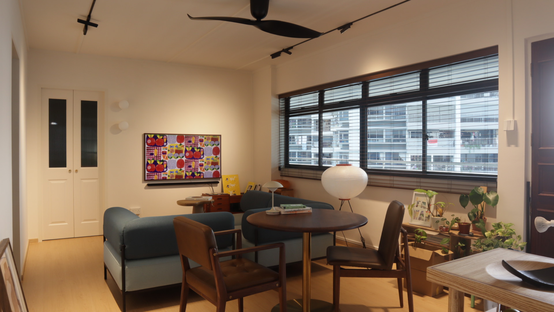 small lights, big vibes; tips on lighting design in your home - Modern living room with contemporary furniture, blue sofa