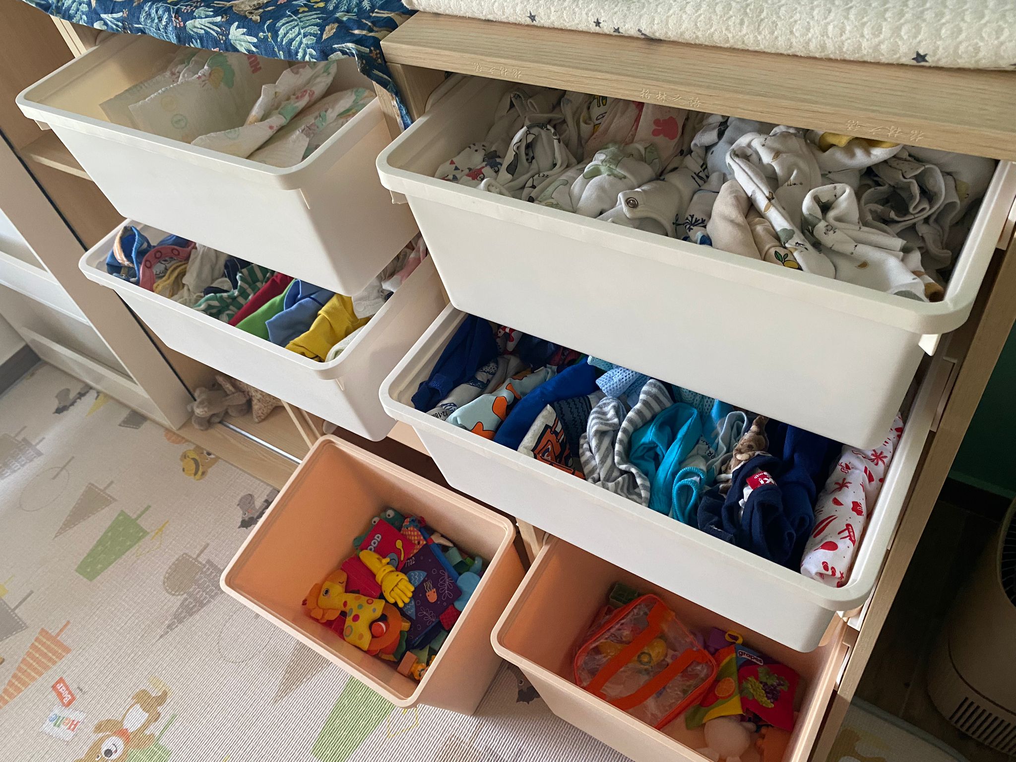 My son's room: Montessori concept where less is more - multi-colored baby clothes, baby clothes organization, baby storage