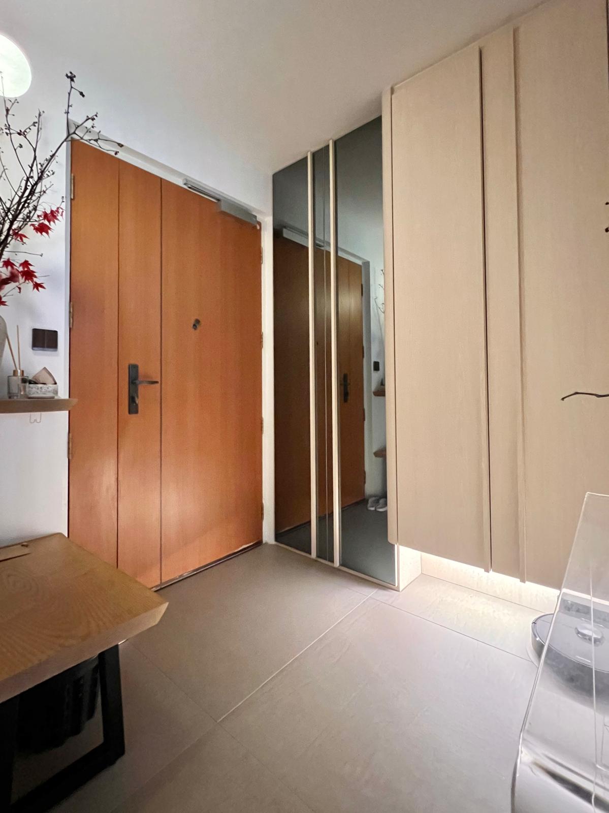 Transform Your Entryway: Stylish Shoe Storage & Smart Organization Tip - Wooden doors, mirrored closet, minimalist design