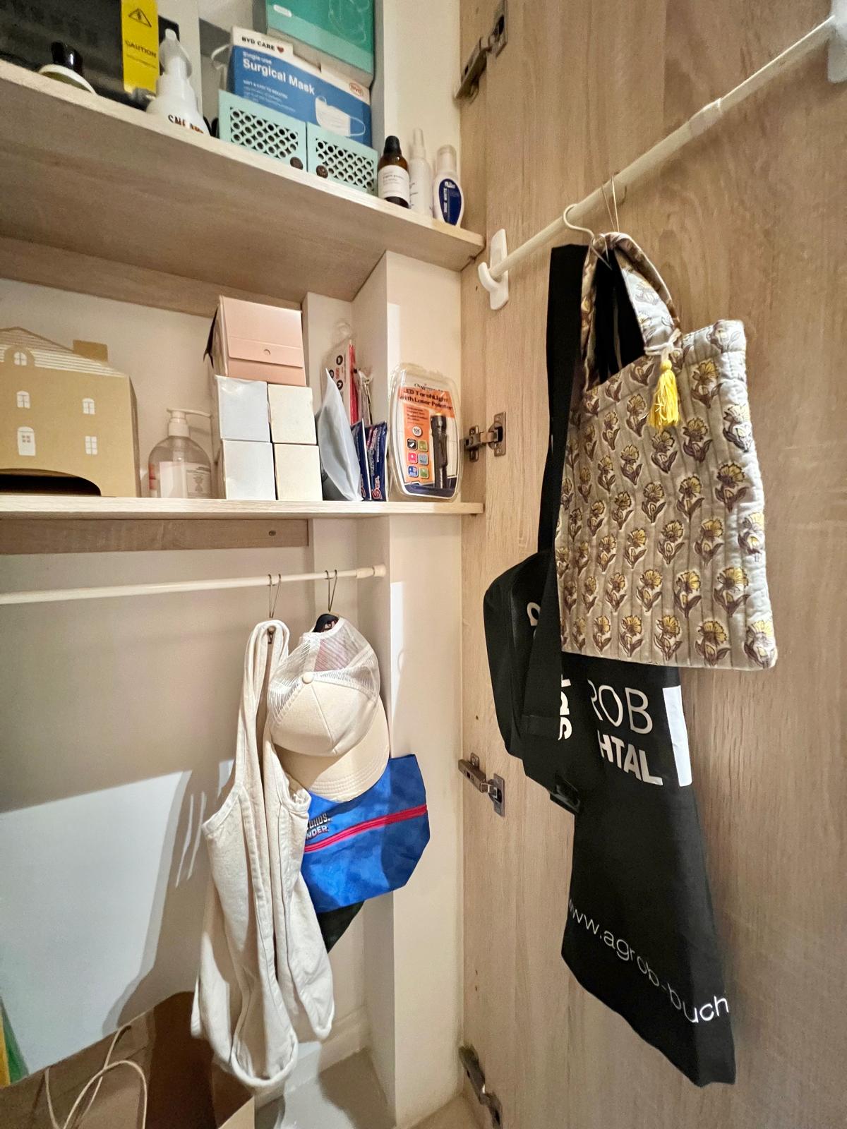Transform Your Entryway: Stylish Shoe Storage & Smart Organization Tip - Storage room, hanging clothes, beige bag, black bag
