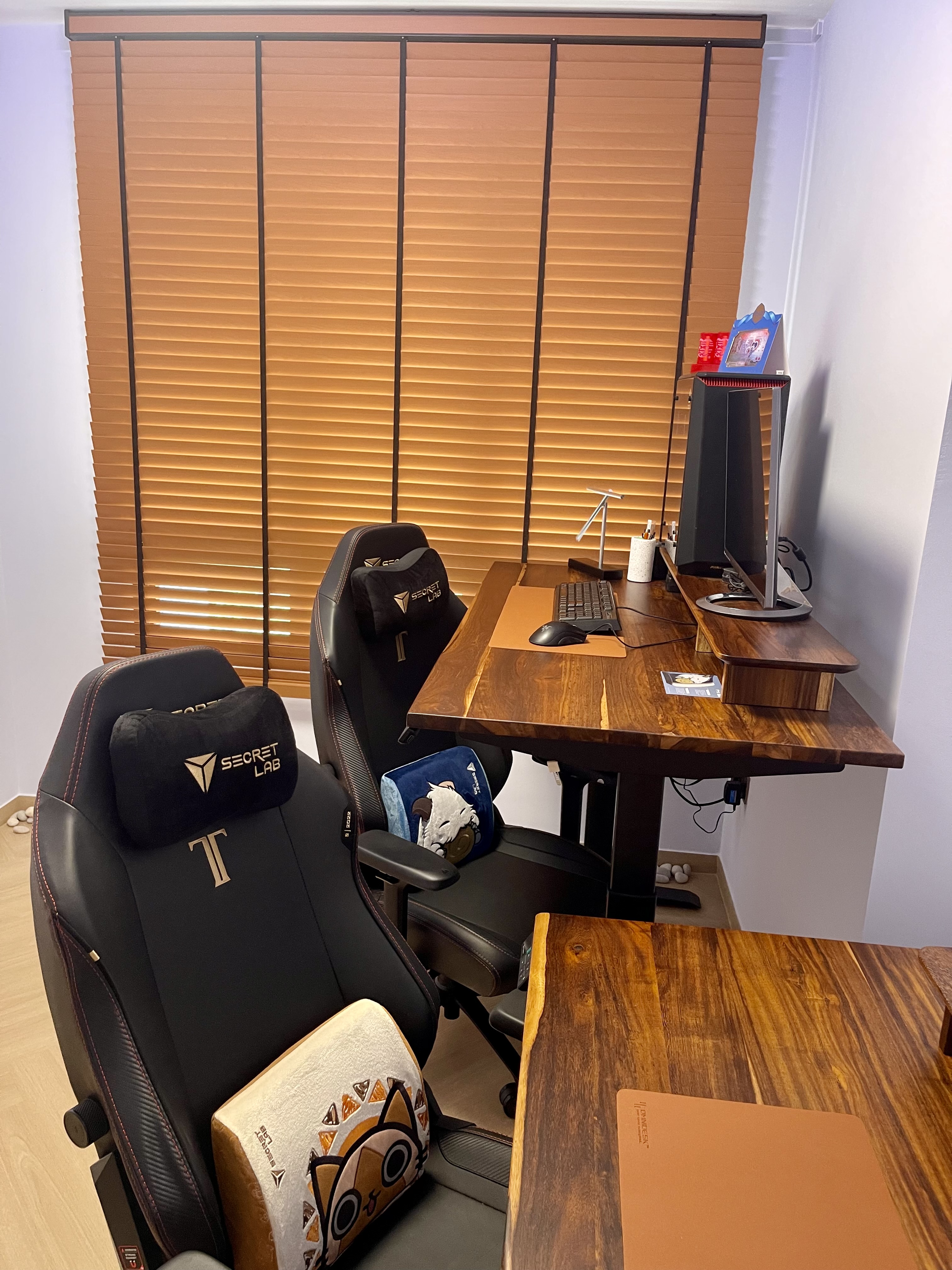 Our Minimalist Sunlit Workspace: Motorized Venetian Blinds & Greenery - Wooden desk, black gaming chair, ergonomic design