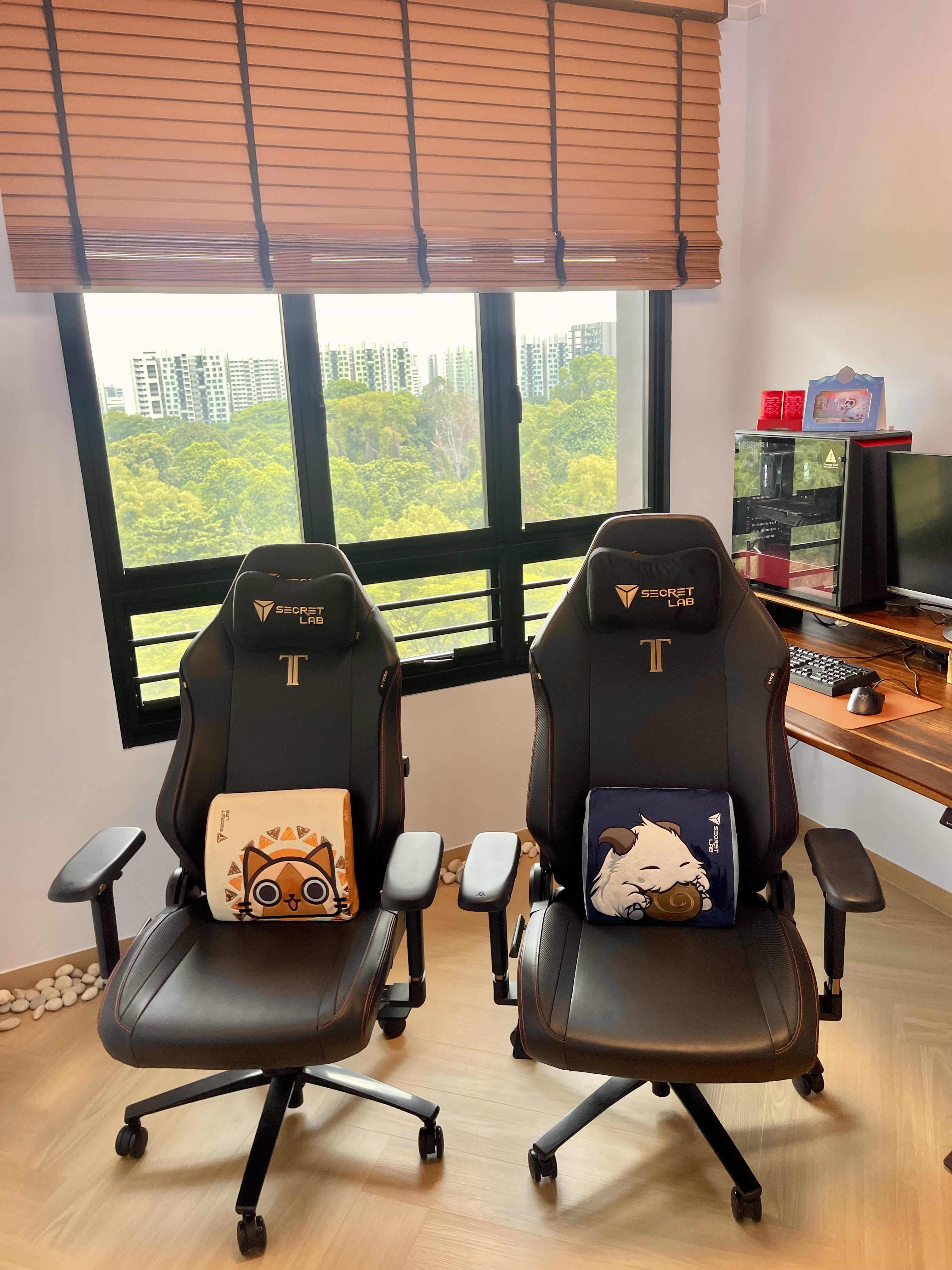 Our Minimalist Sunlit Workspace: Motorized Venetian Blinds & Greenery - Black gaming chairs with orange accents, featuring